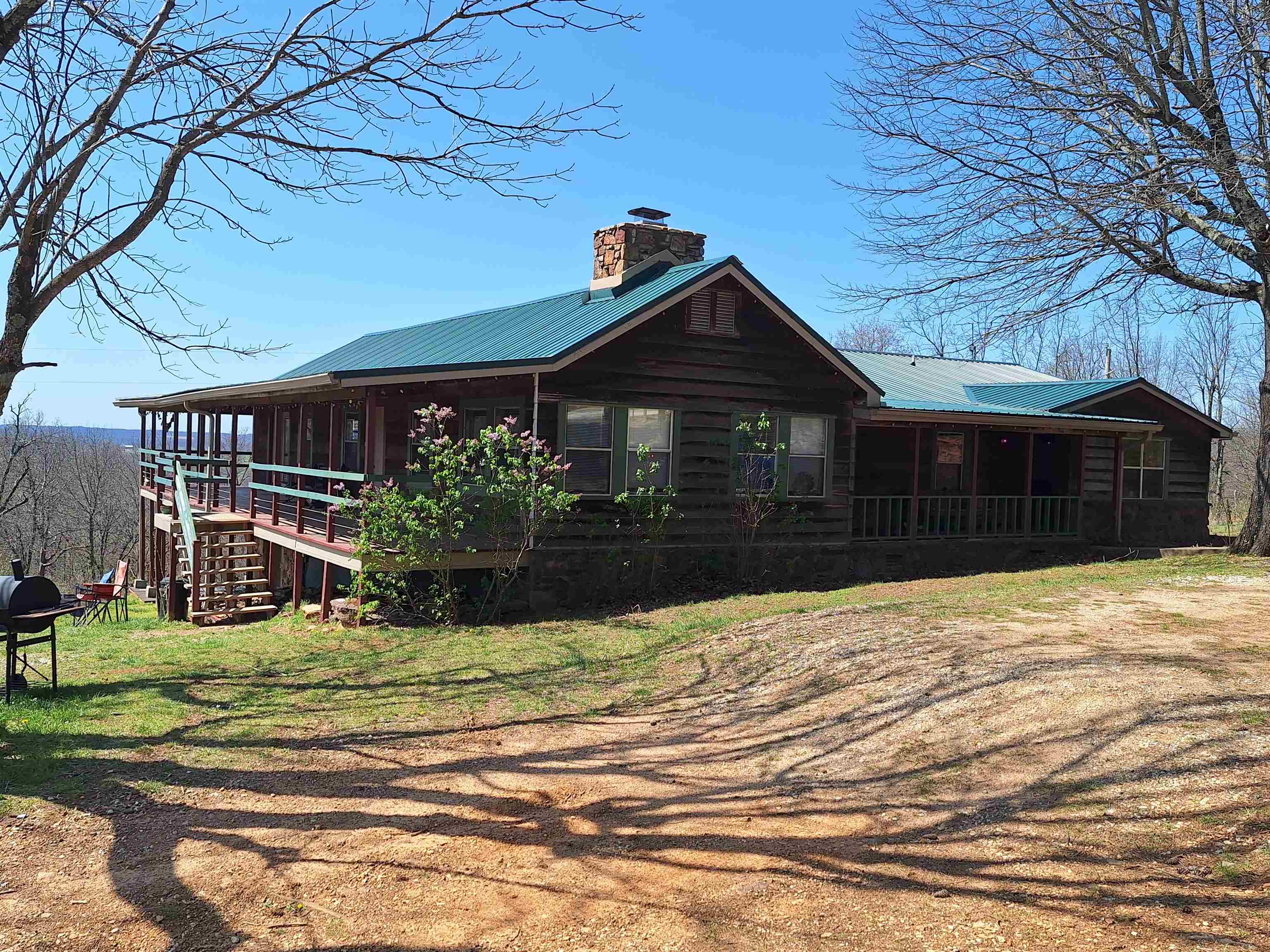 Looking to invest in a property or a way to make some extra cash? This home is nestled on 9.11+/- acres of land, 5 acres of pasture. The current use of the residence is as a sophisticated Air B-n-B, offering tent sites and RV hookups. With horse stalls available for equestrian enthusiasts, this property caters to individuals in search of a peaceful sanctuary following exhilarating trailblazing escapades or a hunting camp. Conveniently located across from the Centerpoint Trailhead with hundreds of miles of trails in the National Forest. The main level of the home features 5 bedrooms and 3 bathrooms, with an office area, while the basement comprises two interconnected suites with kitchenettes that can function independently with private entrances. Much of the home has new custom cabinets and many upgrades, including some new doors and windows. Step outside to the rear of the residence to relish the breathtaking panoramic vistas from the balcony, lower porch, or while relaxing in the yard. A separate structure provides supplementary living quarters complete with a kitchen and bathroom facilities. A workshop situated on the property with spray foam insulated and electric.