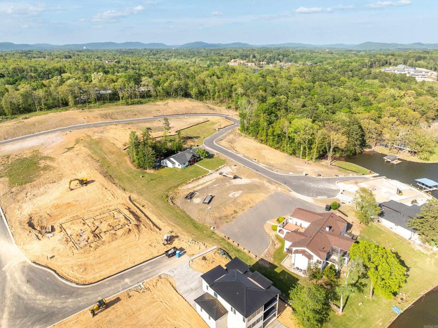 Discover the perfect opportunity to build your dream lakefront getaway on this exceptional lot on the highly sought-after Lake Hamilton in Hot Springs, Arkansas. With approximately 157 feet of pristine shoreline giving it enough for a 2 stall boat dock , this property offers breathtaking water views, year-round access, a private boat ramp and the serene lifestyle that only lake living can provide. Whether you envision a private retreat or a luxurious modern build, this lot is ready to bring your vision to life.  Conveniently located just minutes from downtown Hot Springs, you’ll enjoy easy access to dining, shopping, Oaklawn Racing Casino Resort, and Hot Springs National Park—all while savoring the peaceful atmosphere of lakeside living. Utilities are available at the street, and the lot features gentle terrain, ideal for a variety of architectural styles.  Lakefront properties like this are rare—don’t miss your chance to own a piece of paradise on Lake Hamilton!