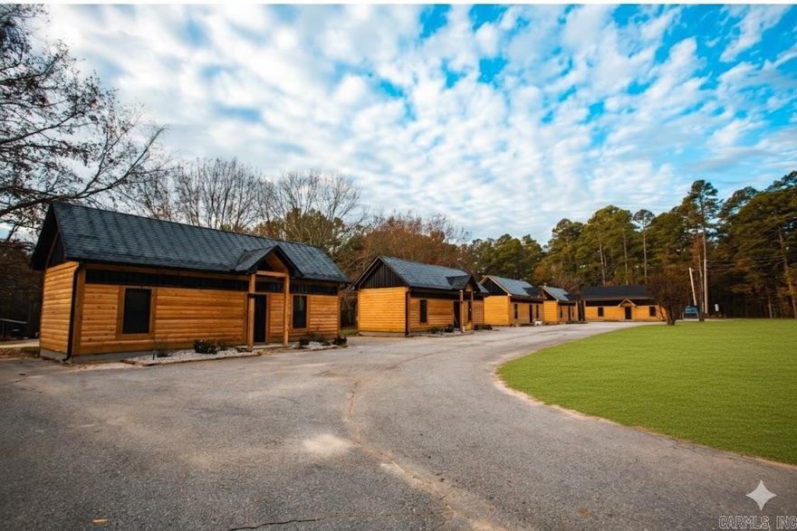 6 beautiful Lake DeGray Cabins. The perfect turn-key opportunity for your vacation business! These cabins blend the rustic, cozy essence of a traditional cabin with modern design and a strong connection to the surrounding nature. Stepping inside, the vaulted ceilings and open concept of the interiors feels spacious and welcoming. Every detail was meticulously designed for comfort and function!  Guests return to their cabin after a day on the lake and make dinner in their kitchen. No need to hand wash dishes afterwards, there's a dishwasher for that!  Sit around a fire on the back porch and watch the deer and wildlife that frequent the property. Get cleaned up for bed in the custom tile showers, then turn in for the night by watching a movie together in the comfortable living room. Mini-splits heat and cool each cabin (efficiency bonus) and concrete floors  keep things low-maintenance. Space for expansion! Lake DeGray is one of the top 5 most visited state parks in Arkansas, has been ranked a top 100 Bass fishing lake, and is nationally ranked for cleanliness. This property is as close as you can get to being on the lake - it is next to the Corps land. 4 minutes to the boat ramp!
