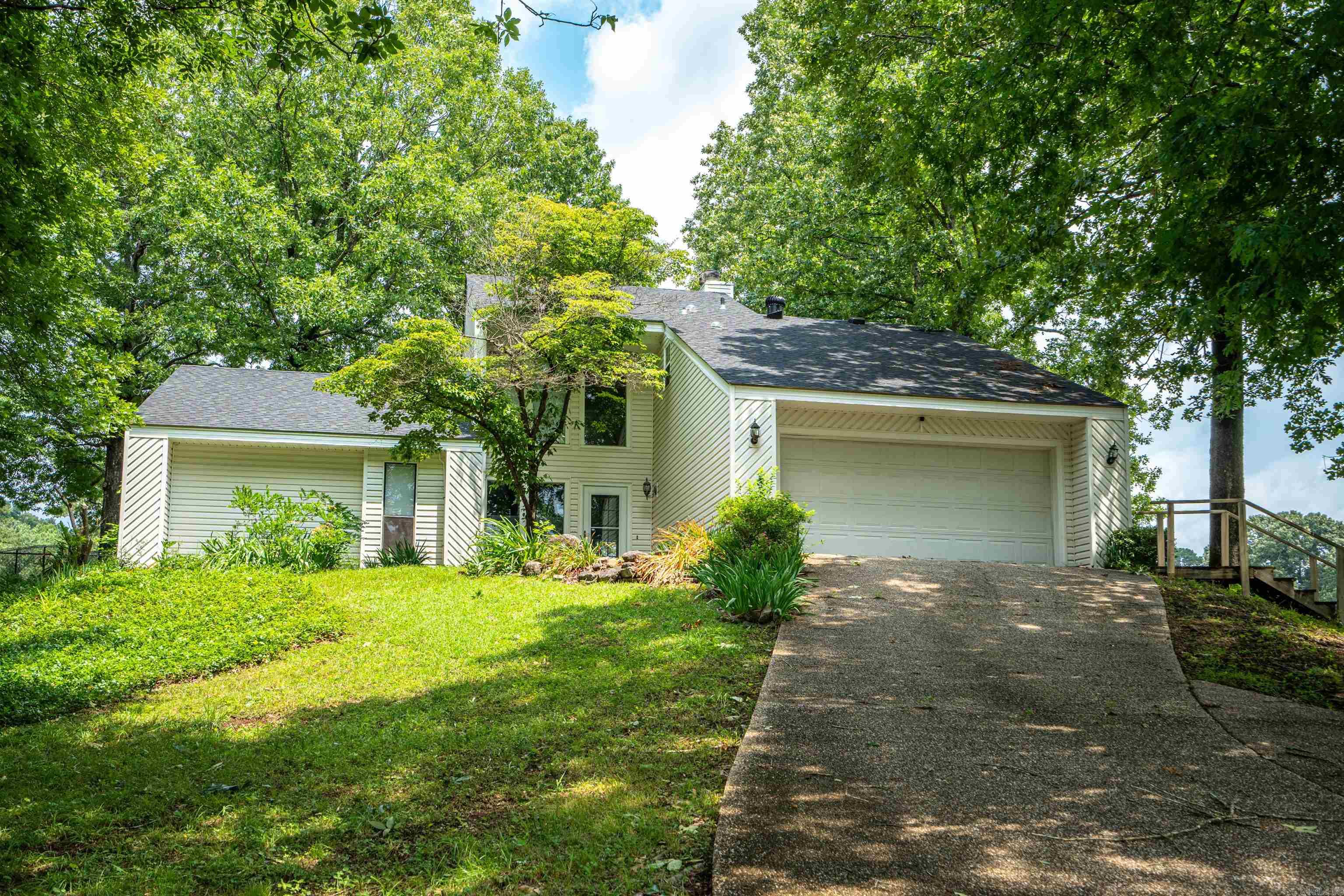 Highly Motivated Seller! Contemporary home located on the golf course in the gated community of Diamondhead. Spacious home with 3 bedrooms (2 are ensuite) and 3 bathrooms. Fireplaces in both living room and upstairs bedroom. Kitchen is open to dining room and living room. Custom blinds in kitchen, downstairs bathroom and landing. Upstairs the very spacious ensuite bedroom has a balcony with beautiful views of the 12th fairway, huge walk-in closet and a new freestanding tub. Downstairs ensuite has a generous bathroom and a large walk-in closet. New roof October 2023. New carpet April 2024 on stairs and downstairs bedroom's closet. Fridge and washer/dryer conveys.