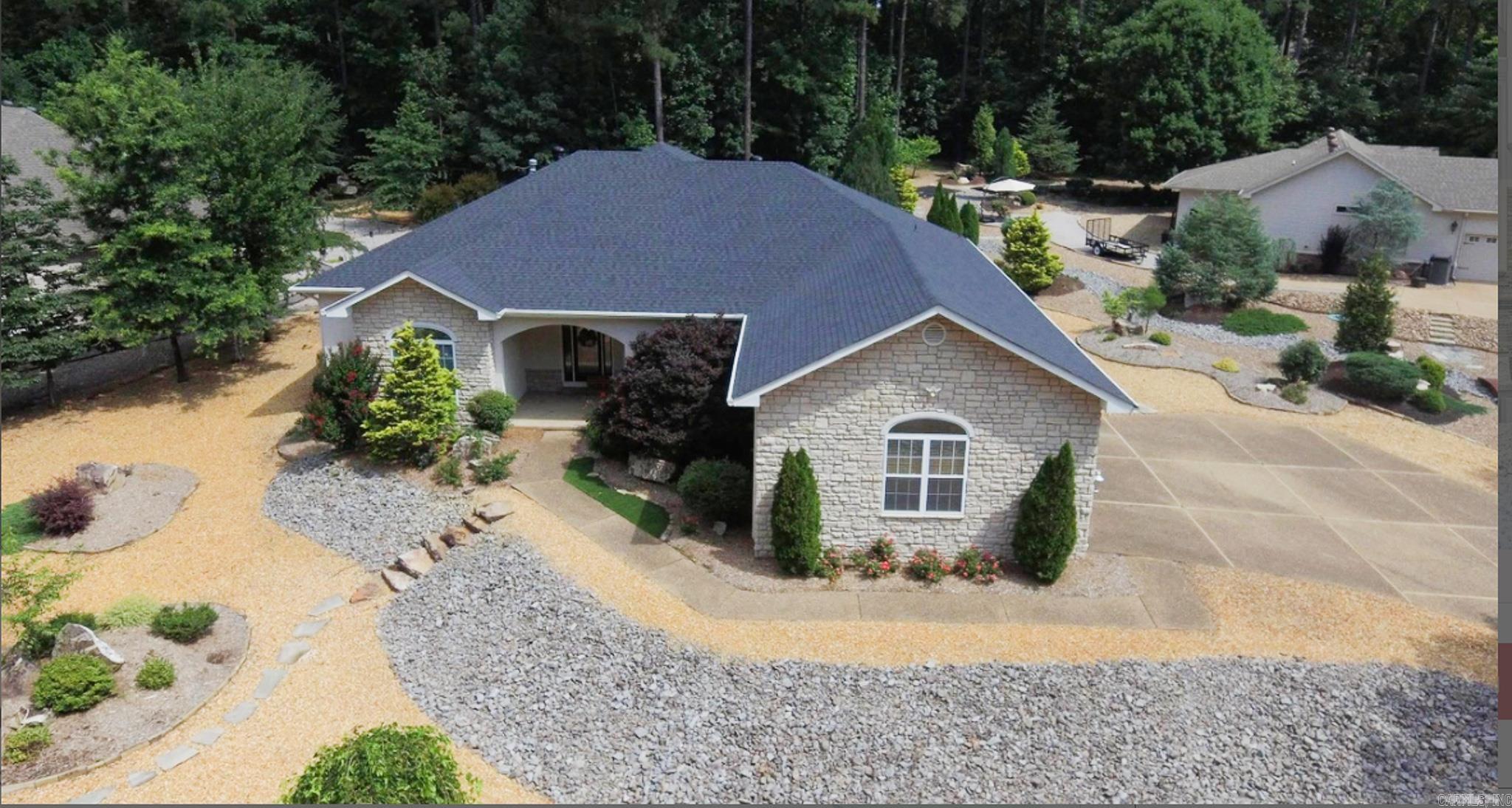 Spacious one level home with a private park like back yard. Comfortable living with large family room off the kitchen. Dining area off kitchen with built in coffee bar area. Kitchen has walk in pantry, island, stainless steel appliances, convection oven/microwave and extra built in oven. Slow-close drawers. Recirculating Hot Water with brand new Marathon Hot Water Heater (lifetime warranty). Recently new Lennox top of the line HVAC. Roof replaced February 2024. Master bedroom and office/bedroom seperate from guest quarters. Master has 2 extra large walk in closets. Guest quarters has 2 bedrooms with Jack n Jill bathroom. Access to Arkansas room. Two heated & cooled storage/workshop areas. Garage deep enough for large truck and car. Separate garage door for golf cart. Level driveway. SEE AGENT REMARKS
