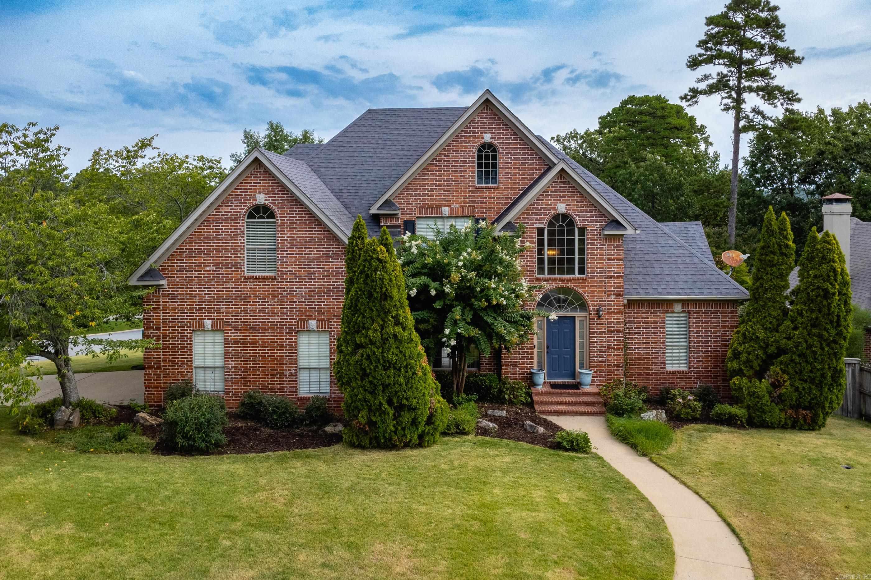 Set on a corner lot on quiet and secluded Sawgrass Court, this light-filled home delivers an easy, open layout with the primary suite tucked away for privacy. A large living room with vaulted ceilings opens to an updated kitchen and breakfast nook for casual dining and opens to back deck. The main level also offers a separate, guest bedroom and full bath, plus a laundry room with utility sink. Upstairs you will find two additional bedrooms, a hall bath and a large bonus room with a closet that can serve as a fifth bedroom, playroom or media room. Enjoy quick access to Chenal and Cantrell and everyday conveniences just minutes away. Zoned for Don Roberts and Pinnacle View and only five minutes from the Little Rock Promenade. The blend of an open, livable layout and an unbeatable location makes 2 Sawgrass Court the perfect place to call home.