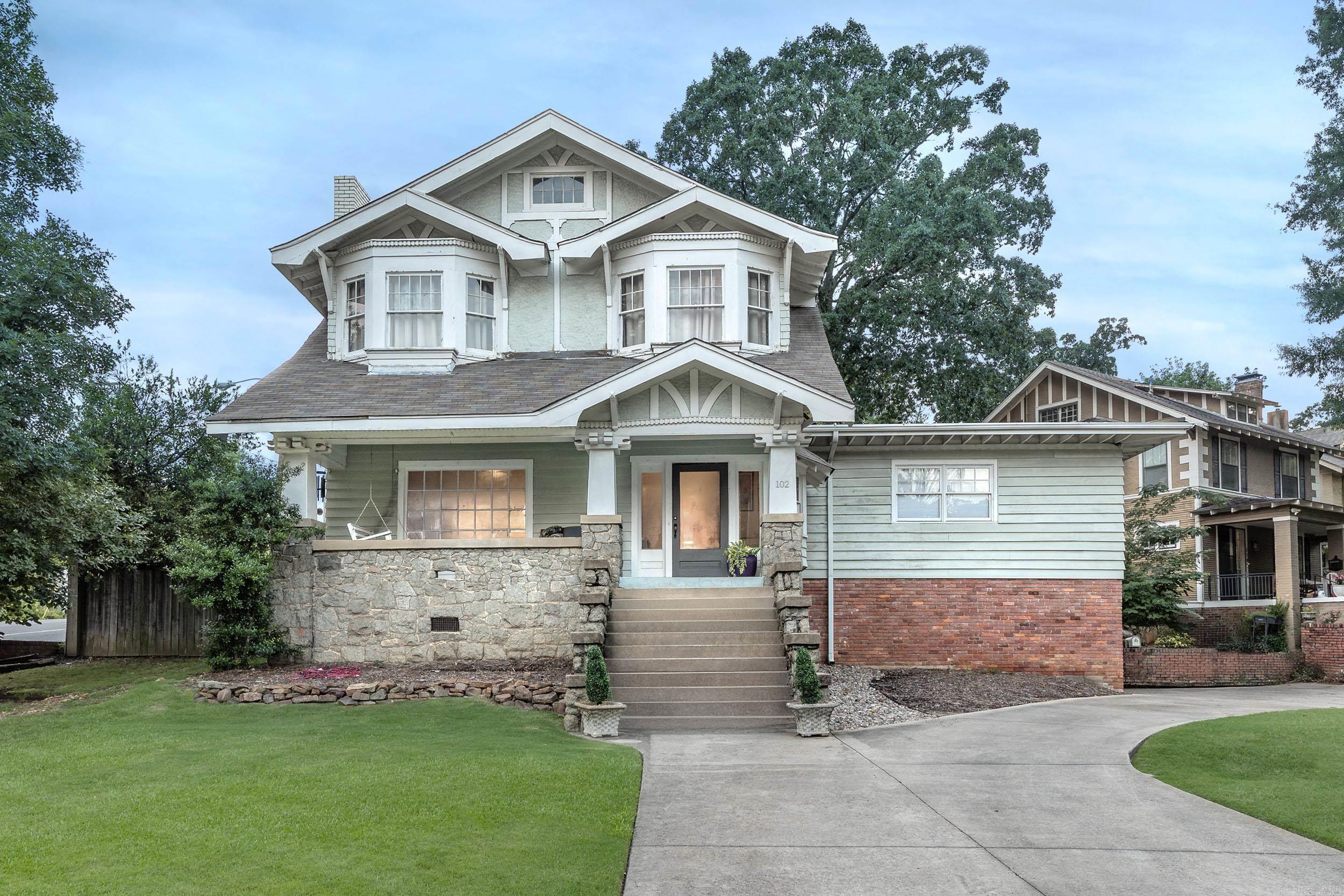 This isn’t just another Hillcrest home—it’s a showstopper on one of the largest lots in the neighborhood. Sitting on a rare 0.5-acre corner lot, this 4 bed, 3 bath Craftsman blends timeless character with modern upgrades and unbeatable functionality including tons of closet space. Inside, the open floorplan is filled with natural light & historic charm—from original hardwoods & classic trim to bold designer finishes. The updated kitchen steals the show with quartz countertops, custom navy cabinetry, a gas range, & lots of workspace. The large dining room, full of windows, flows into multiple living spaces & out to a deep front porch for relaxing. Upstairs the three bedrooms are spacious & updated. Downstairs bedroom offers flexibility for playroom or office. Outside, enjoy a huge fenced yard, mature trees, patio, & plenty of space to roam or entertain. Bonus: the 1,100 SF guest house with 1 bed & 1.5 baths, private entrance, deck, & separate electric meter—ideal for rental income, in-laws, or work-from-home life. With a newer roof, updated wiring/plumbing, a circular driveway, & a rare 2-car garage, this is a forever home in the heart of Hillcrest.