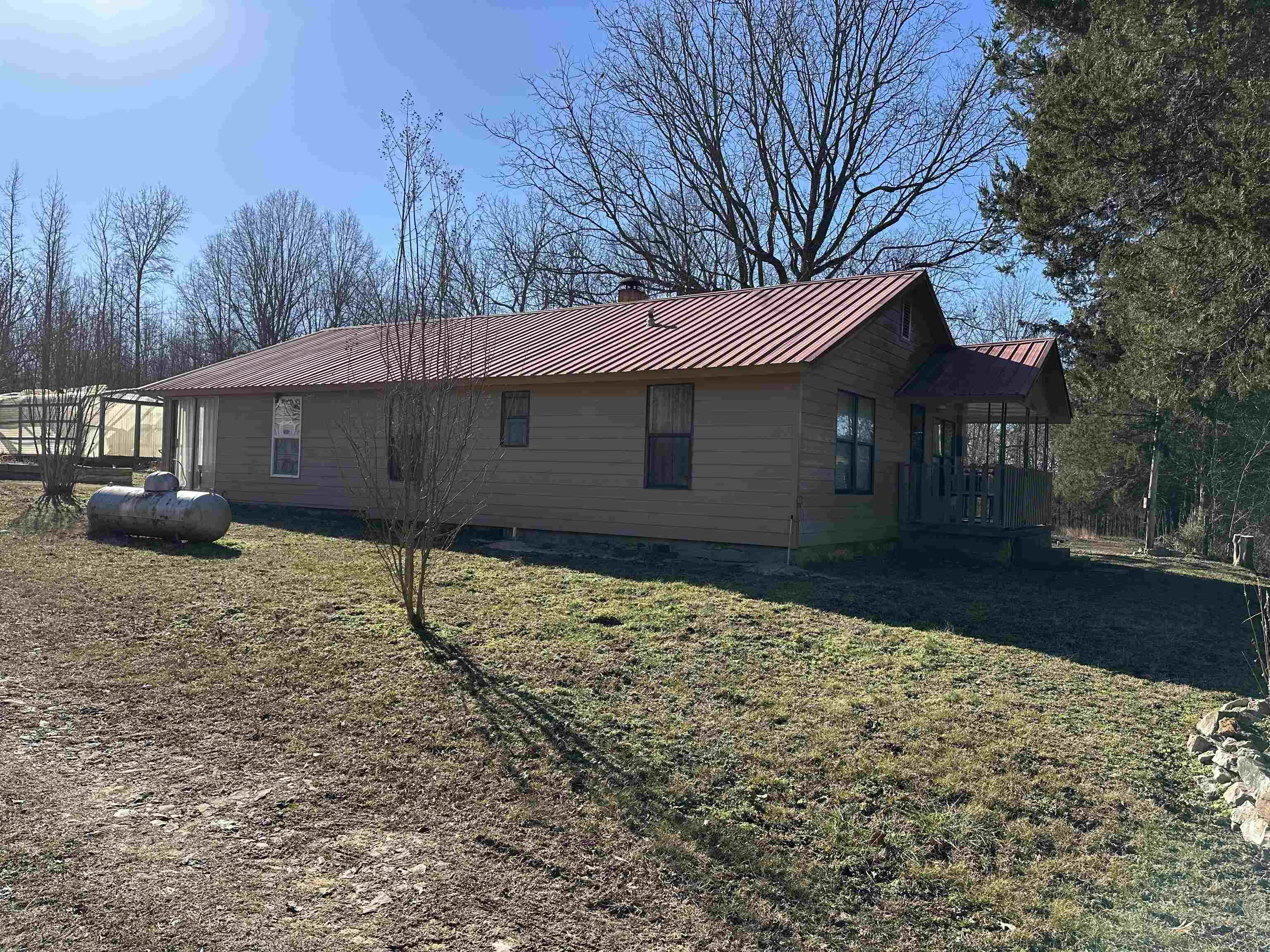 Home and 40 timbered acres alone blacktop road. 2 bedroom 1 bath wood heat and window air. well water, propane for water heater and cook stove.