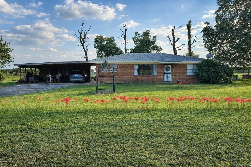 31610 Hwy 54, Dumas, AR – Lincoln County This charming brick home offers highway frontage with the privacy of no immediate neighbors. Key features include:3 bedrooms, 1 bath, Brick exterior with a durable metal roof, Double carport, Yorktown water supply, Wood kitchen cabinets, attic fan that acts as an exaust fan, Water filter for the whole house, RV and boat shed + grain bin fwith concrete floor for your storage, Central heat and air with emergency heat heaters, 1.5 acre  lot with no one living directly beside you.  Enjoy quiet country living with convenient highway access! Some cosmetic updating will be needed so it is priced accordingly. Possible to do an RD loan if you add to do a repair escrow.
