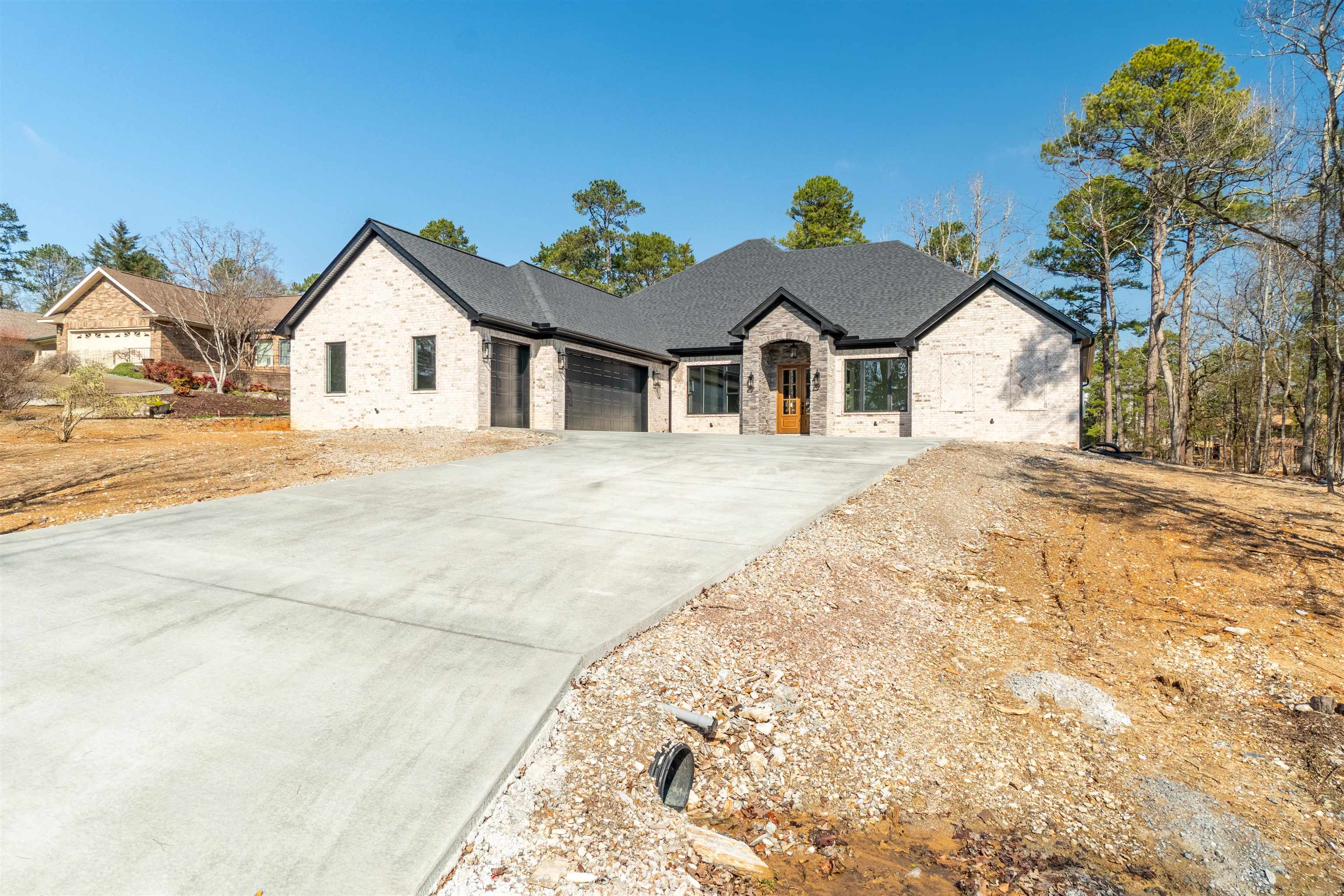 WELCOME HOME!!!! This BRAND NEW 2025 Construction home is ready for you! Relax on the beautiful covered back patio. Enjoy nature, golfers, your morning coffee, or your evening wind down time. Divided bedrooms, vaulted ceilings, a very spacious pantry and under cabinet lighting in the kitchen and primary bath. Be sure to check out the drawers in the primary - already set up with electrical for all your hair tools! Guest bath features dual sinks as well - very unusual - but very convenient for your guests. The mudroom, just off of the garage, is the perfect place for all those shoes, gloves, hats, etc. Grand, sweeping view of the golf course with Northern exposure and the cart path across the course ensures a level of quietness from the golf carts. Make 2025 your year to finally make the move to your DREAM HOME in beautiful HOT SPRINGS VILLAGE! SEE AGENT REMARKS.