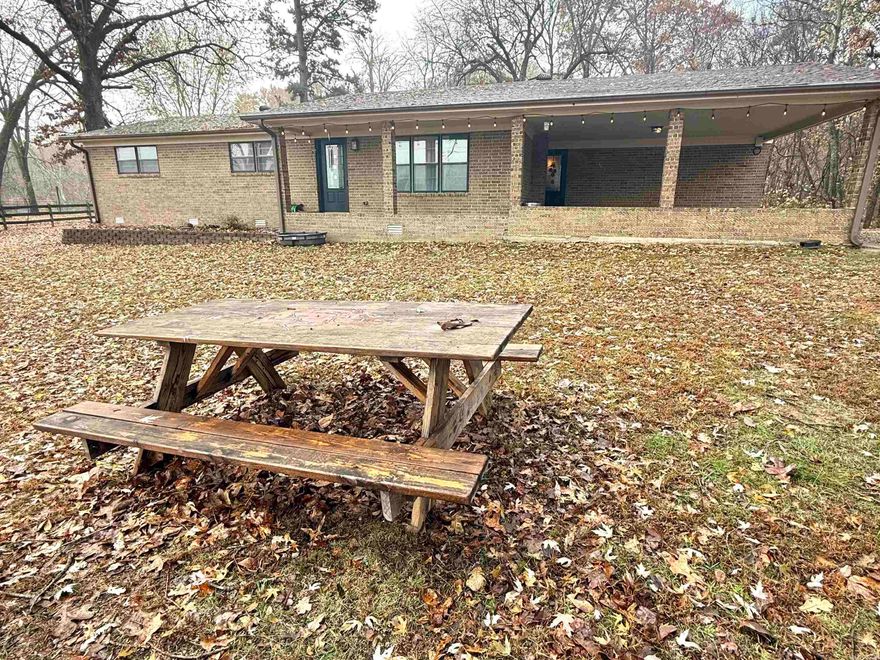 Discover the kind of country living everyone dreams about with this charming 3 bed, 2 bath ranch-style home on 8.60 +/- acres with a fishable pond, two spacious living areas, and a large powered shop. This 2,256 sq ft home features a brick, wood-burning fireplace, a huge den, large laundry room with laundry sink, and a freshly stained deck(2025). The property includes a hardy stove, double carport, basketball pad, second shop, and fiber-optic internet. All of this less than 2 miles from a great swimming/fishing creek. Major updates include new roof(2024), water heater(2021), 10 year exterior seal/paint(2024), updated outlets, and new insulation around den windows. Your country lifestyle starts here- come see why this one stands out above the rest!