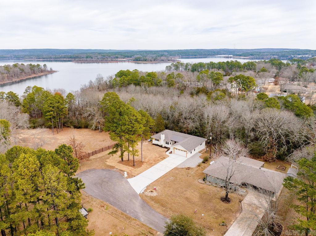This Lakefront Home has it all! Short golf cart ride to Thunderbird Country Club/Golf Course & all amenities, path permit to quiet Greers Ferry Lake cove . Damsite Recreation/Marina short drive away. This beautiful home has been totally remodeled inside and out. The quality of workmanship is so good you can not tell the new construction portion from the original home. Two Master Bedroom suites with private baths, 5 total BR's & 4 full BA's, main living room and lower level Game Room/Den. Exterior with upper level deck and lower level stone patio & firepit area. The perfect full time home or weekend retreat with the ability to vacation rent if desired, located at the end of the cul-de-sac. The home has been staged with all new furniture and decor that can be purchased for an additional cost. SEE ASSOCIATED DOCUMENTS FOR ADDITIONAL INFORMATION ON REMODEL, SURVEY AND FURNITURE/DECOR COST