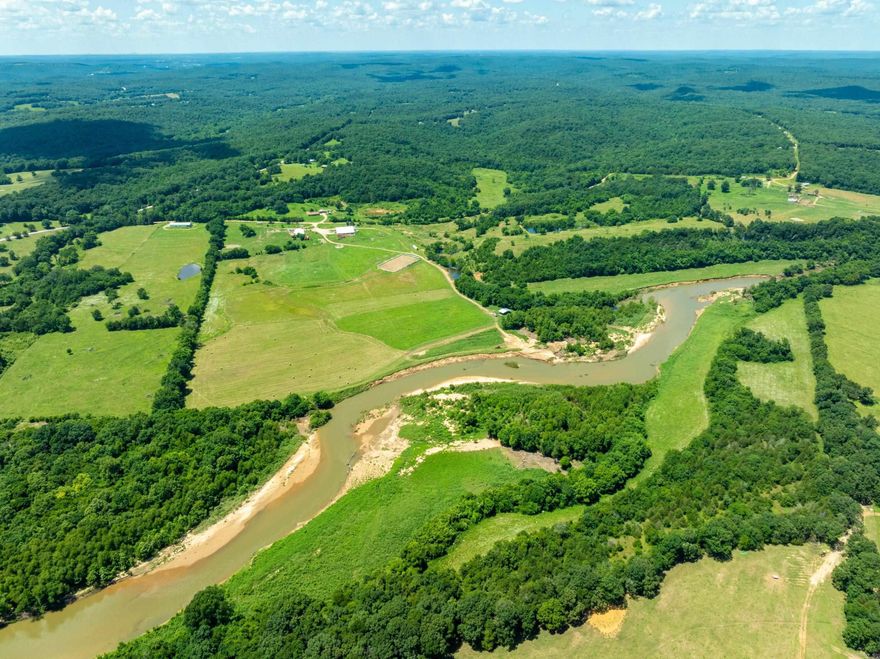 Ultimate Ozark Riverfront Retreat – 200± Acres with Barn, Arena, Shop & River Frontage  Over 4,000 ft of Strawberry River frontage—sandbars, fishing, swimming, kayaking & rock cliffs—this Sharp County gem is a dream for outdoor lovers! Approx. 75 % hay fields producing 250–300 bales/year, some mature woods for hunting (deer & turkey), ATV trails, and cross-fenced pastures with some goat fencing.  A massive 9,000+ sq ft barn features spray foam insulation, large fans, horse stalls, a tack room, toilet room & living quarters. Lower level is handicap accessible with oversized bedrooms, each with custom tiled roll-in showers, roll-under sinks, mini-split HVACs, and windows facing stalls. Main floor offers 3 beds, huge laundry (2 washers/dryers), and a common area. Upstairs includes a full kitchen, living area, balconies, and 4 more private bedrooms with private baths & stall views.  Working arena, equipment shop with lift, creek frontage on both sides, only ¼ mile off gravel road. NAEC electric, NEXT fiber internet, Grange Calamine water.  Perfect for a horse facility, lodge, retreat center, or private estate—this rare property blends luxury, functionality, and unmatched natural
