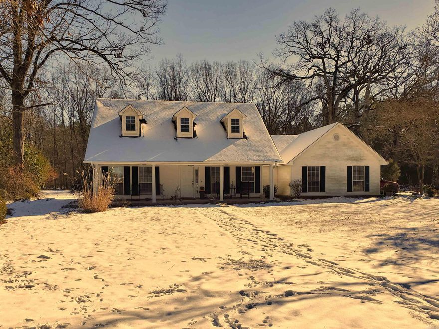 What a wonderful find on a 20 acre parcel! The custom built 3 bedroom 2 bath home has a formal dining room (could be office), propane fireplace, and a HUGE primary bedroom and bath with 2 large walk in closets. The floors are mostly hardwood with carpet in 2 bedrooms (buyers can choose the carpet color) and tile in entrance and kitchen. There is a horse barn built about 8 years ago with a separate fenced area for the horses. AGENTS SEE DOCUMENTS & REMARKS.