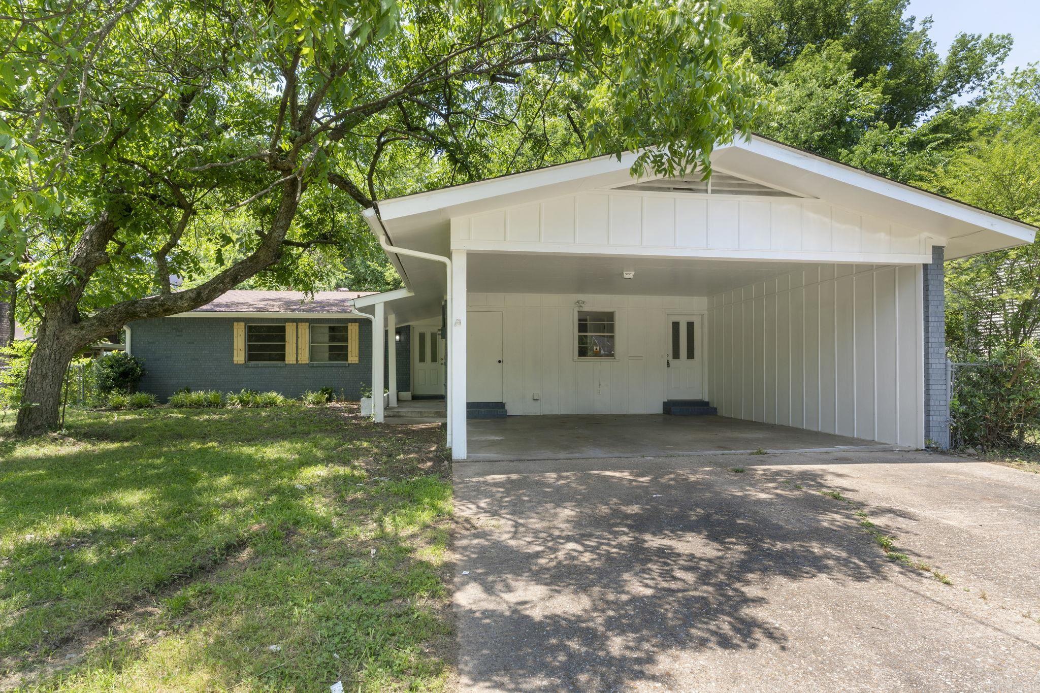 This lovely home, located on a quiet street in the heart of Morrilton, has been recently updated. The curb appeal will draw you into this charming home that is full of character. The main living area has a beautiful brick fireplace with floating shelves on either side, making this room the perfect space to relax after a long day. The kitchen is conveniently placed next to this den and has a breakfast bar for casual dining and a HUGE walk-in pantry/storage area. Opposite the kitchen, you will discover an ample additional living space that leads into the backyard with a covered back patio. Three bedrooms and two bathrooms complete the private areas. Updates include fresh paint, new floors, lighting, faucets, fixtures, appliances, tons of storage space, tile surround tubs, and much more. BRAND NEW HVAC!!