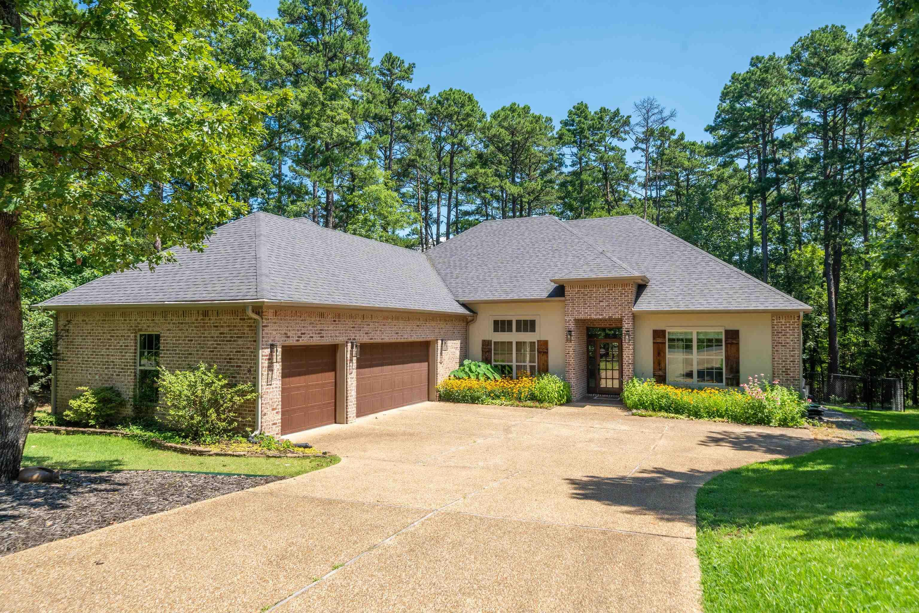 Enjoy comfort in privacy in this beautifully designed home situated on two lots with a fenced backyardāperfect for outdoor living and pets. Step inside to an inviting Arkansas room and living room filled with natural light through large glass windows. The open-concept kitchen flows seamlessly into the living room and features a bar-height counter, ideal for casual dining or entertaining guests. This well-maintained property offers a level lots, a spacious 3-car garage and convenient stairs leading to a partially floored atticāgreat for storage. The primary suite includes a luxurious walk-in Roman shower, and the over sized laundry room adds everyday ease. With space, style, and smart layout, this home is ready for you to enjoy both inside and out! AGENTS SEE REMARKS