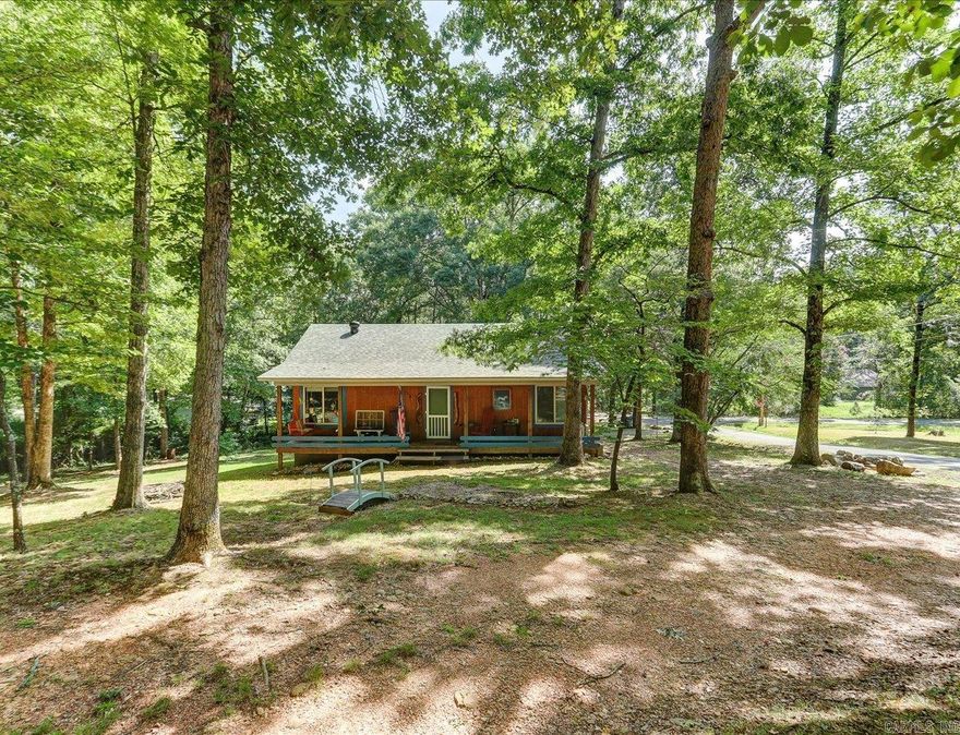 LOCATED JUST MINUTES FROM BOTH LAKE HAMILTON AND LAKE OUACHITA! 1 bed, 1 bath, 988 SF 1 owner home with an unfinished loft area built in 2013. This property sits on five spacious lots and includes three septic systems, offering flexibility and potential for future use.  The main house is serviced by one septic tank, while a second septic supports the detached guest house, which is currently used as a laundry room but could easily be converted back to guest accommodations. A third brand-new septic tank is also on the property, providing even more opportunity for expansion.  The home is on city water, but there’s also a well on-site—while the seller hasn’t used it and the condition of the pump is unknown, it’s a valuable feature worth highlighting.  Inside, you’ll find a cozy and efficient living space with mini-split HVAC systems, professionally serviced twice a year by McGrew. A new roof was installed just a few years ago, adding to the peace of mind for the next owner.  Whether you’re looking for a primary residence, a weekend retreat, or a property with guest or rental potential, this property has plenty of potential.   Agents - please schedule all showings with Showing Service.