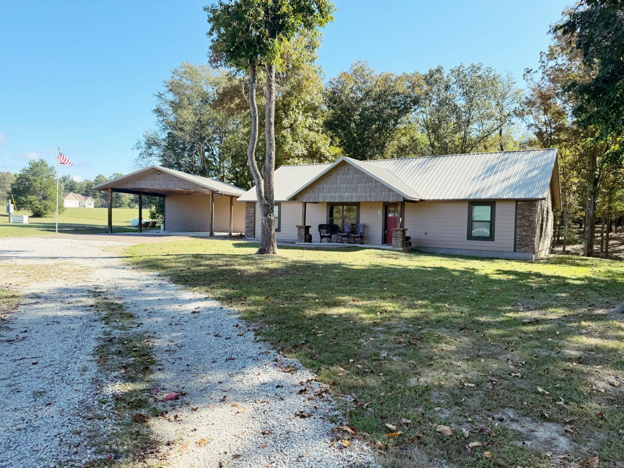 This home has 1,797 sq. ft. of total living space, including a 1,557 sq. ft. main house featuring 3 bedrooms and 2 bathrooms. The open floor plan has vaulted ceilings with rich wood finishes, a beautiful stone fireplace, and brand-new flooring throughout. The kitchen offers stainless steel appliances, beautiful wood cabinetry, and plenty of counter space.    Relax on the back porch while enjoying the peaceful view of your very own koi pond with a waterfall, surrounded by trees and nature. This property sits on 6.3 acres, giving you room to spread out and enjoy country living while still being close to town.  In addition to the main home, thereās a 2-car carport with a finished 240 sq. ft. bonus space that includes two rooms and a half bath. This flexible area would make a great mother-in-law suite, office, craft room, or guest quarters. A storage shed is also included. The whole house generator gives you peace of mind.  If youāve been looking for a move-in ready home with charm, privacy, and acreage, this one checks all the boxes!