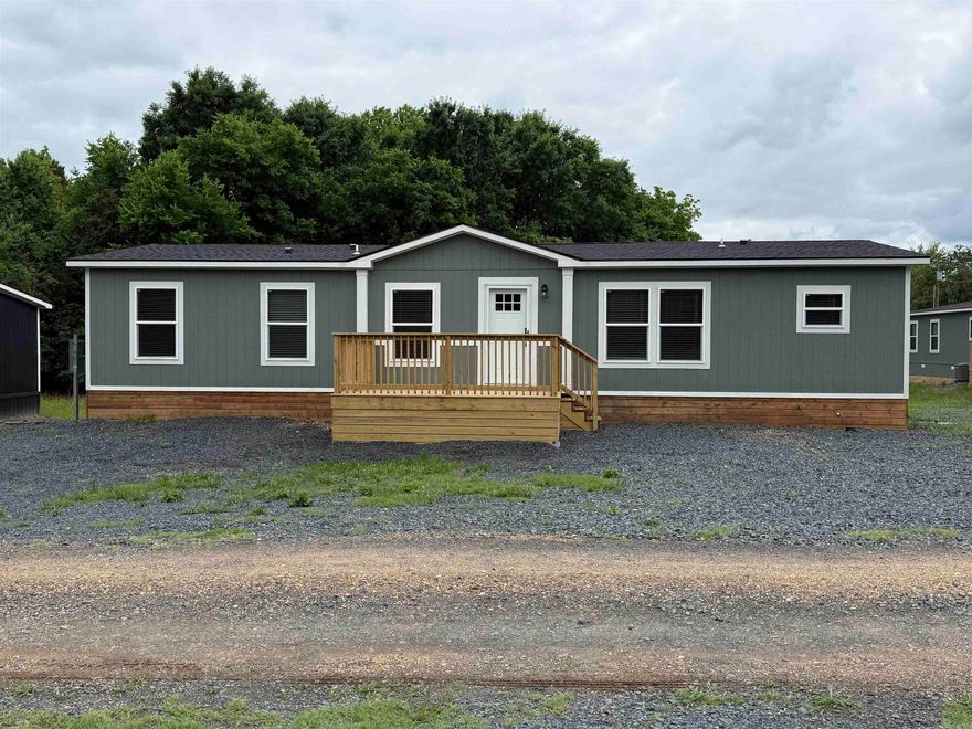 2025 3-bedroom, 2-bathroom manufactured home with approximately 1,568 sq ft, featuring warm farmhouse finishes and a bright, inviting interior. This thoughtfully designed open floor plan offers a spacious living area, oversized kitchen island, stainless steel appliances, light cabinetry, and natural wood-tone accents throughout. The split-bedroom layout includes a private primary suite with a walk-in closet and an ensuite bath. Modern lighting, neutral colors, and comfortable living spaces make this home feel both stylish and welcoming. Permanently affixed to the ground on a concrete slab, making it eligible for government financing per engineering certification requirements. Brand new and move-in ready!  See documents on file for a copy of the Energy Star Certification.