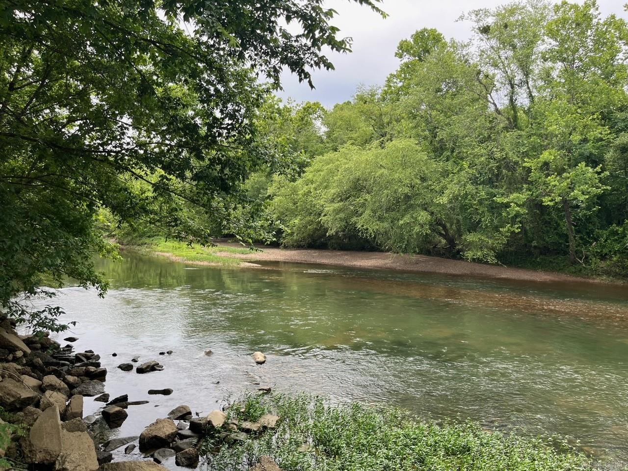 Lot 12 in Caddo Paddock Subdivision has deeded river frontage on the Caddo River. Paved county road access along Old Military Road, municipal water, permitted septic, underground electricity, fiber internet, and deed restrictions serve to protect value as well as enjoyment of the property. Restaurants, float outfitters, and I-30 are less than 1 mile away with Arkadelphia being only 5 miles south. The property has a unique history and is ideal for VRBO investment near DeGray Lake.