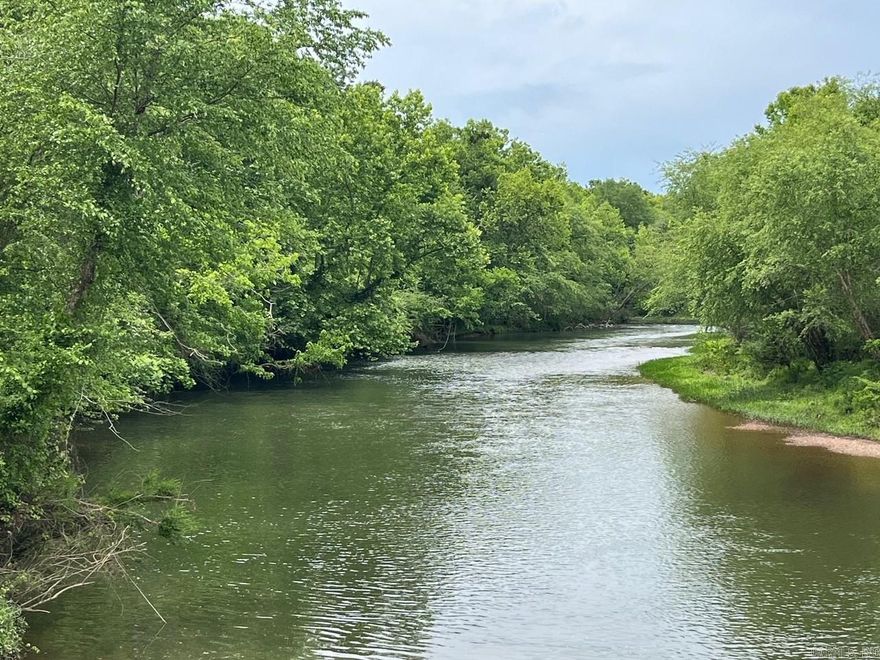 Lot 12 in Caddo Paddock Subdivision has deeded river frontage on the Caddo River. Paved county road access along Old Military Road, municipal water, permitted septic, underground electricity, fiber internet, and deed restrictions serve to protect value as well as enjoyment of the property. Restaurants, float outfitters, and I-30 are less than 1 mile away with Arkadelphia being only 5 miles south. The property has a unique history and is ideal for VRBO investment near DeGray Lake.