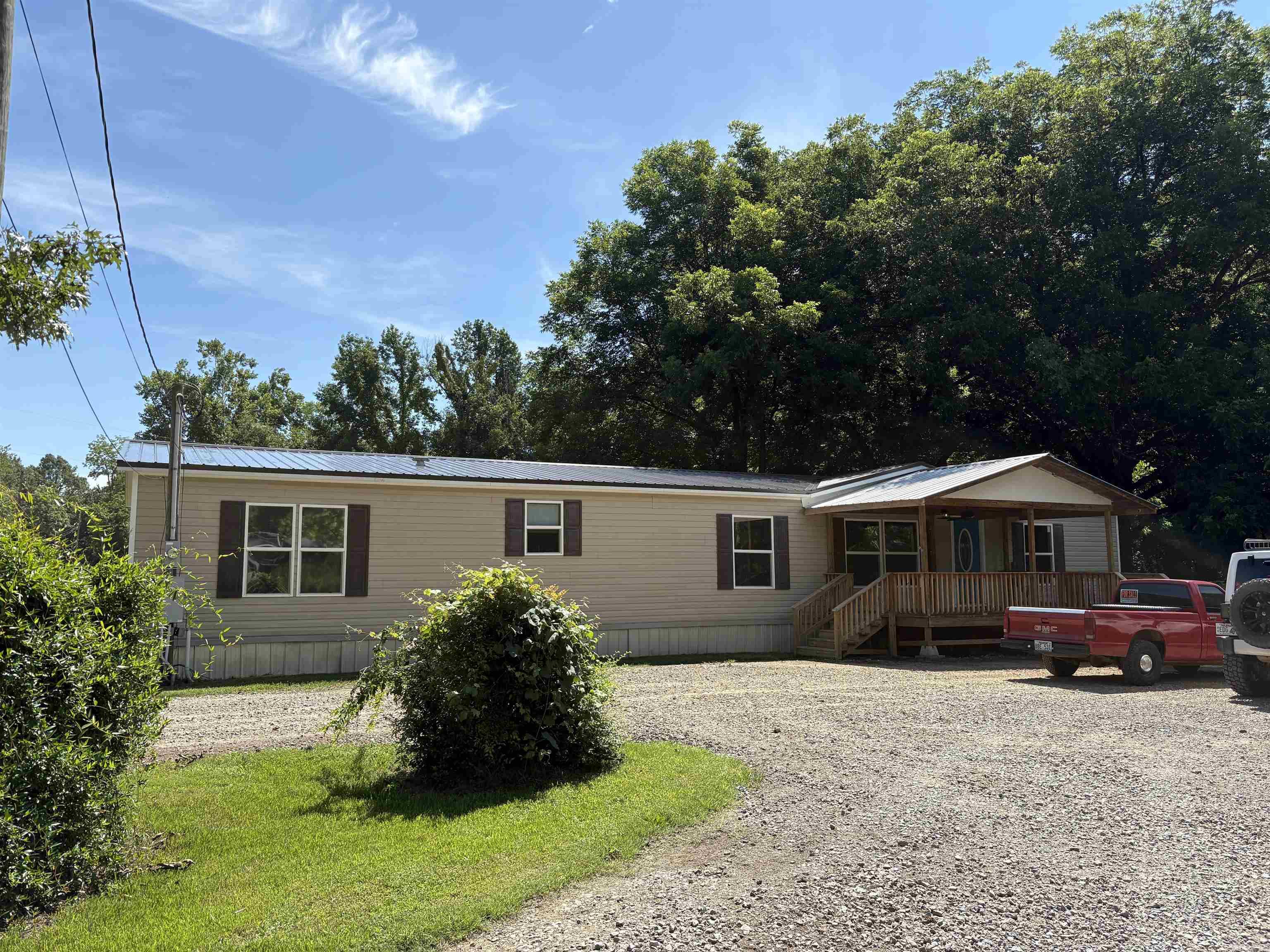 If space, upgrades, awesome tree shaded yard, and peace of mind are your kind of thingāthis is it! This extra-large double wide doesnāt just give you room to stretch out, itās full up on updates so the hard work's already done. Brand New RoofāYep, just a few weeks old with a 45-year warranty and 8-year labor warranty. Sleep easy, rain or shine. Updated Kitchen & AppliancesāModern, fresh, and only 2 years young. New Flooring in the den, dining room, and master bedroom for that move-in ready feel. Walk-in Tile ShowerāBecause you deserve that spa vibe every morning. Window Trim UpgradesāStyled like new construction, so you get the crisp, clean look without building from scratch. Extra Large Laundry/Mudroom with IslandāBecause laundry day shouldn't feel cramped. Surround Sound in the Living AreaāCue the music or movie nights, you're set. Arlo Security Cameras IncludedāPeace of mind stays with the house. Backup Wall Heat Unitā2 years old, just in case Mother Nature gets dramatic. Wired Shed with Window UnitāThe perfect workspace, hangout, or storage zone. Two Sewer & Water HookupsāBring your RV, guest house dreams, or just options. Fenced BackyardāRoom for pets, kids, or your weekend BB