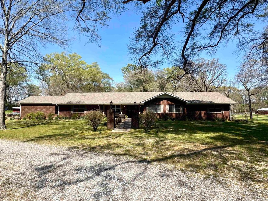 Discover the perfect blend of comfort, space, and country charm with this beautiful ranch-style home situated on 12+ acres. Featuring 4 bedrooms and 4 bathrooms, this property offers a spacious open floor plan ideal for both everyday living and entertaining. A separate den provides flexibility for a media room, or quiet retreat. The home includes a two-car garage and a conveniently located laundry room just off the kitchen and garage for added functionality. Inside, you’ll find a cozy gas fireplace in the main living area. This home has a handicapped accessible bathroom designed for comfort and ease. Step outside to enjoy a stunning screened-in patio with a vaulted ceiling, complete with beautiful views of the surrounding land and barn—perfect for relaxing or hosting guests. Horse or animal lovers will appreciate the well-equipped heated horse barn with 10 stalls, a round pen, and approximately 7 acres of fenced pastureland, including some wooded areas for shade and privacy. The property also features two sheds for additional storage. Additional highlights include a Generac generator, two leased propane tanks, and one owned propane tank for added efficiency and peace of mind!
