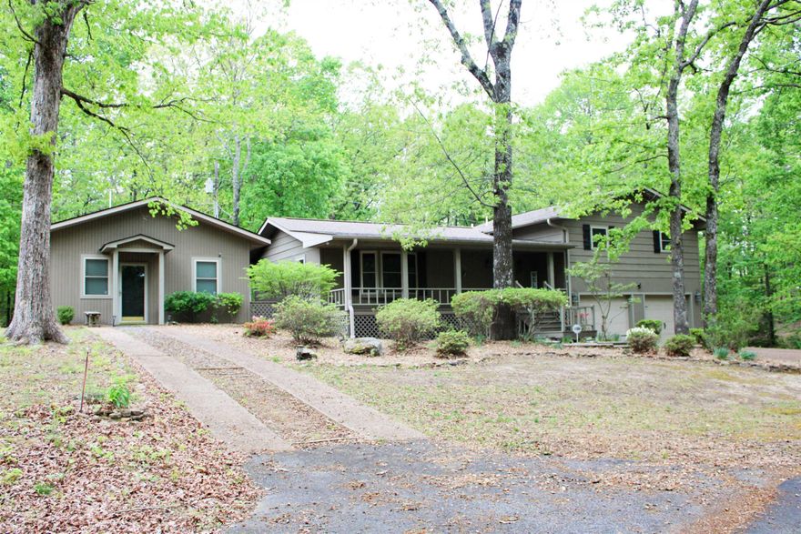 Spacious 4BR/3BA home on nearly 3 private acres near Greers Ferry Lake. Features approx. 2,405 sq ft plus separate living quarters with private entrance—ideal for guests, in-laws, or rental potential. Updated kitchen in 2024 with granite countertops and stainless appliances. Cozy living room with stone fireplace and gas logs. Enjoy outdoor living on the private back deck surrounded by nature. Whole-house generator for added peace of mind. Located in a desirable lakeside community with lake access and close to boating, fishing, and all that Heber Springs has to offer. Great opportunity for full-time living, vacation home, or investment property. (Some photos are Virtually Staged)