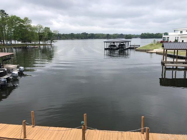 Move in Ready !! Conveniently located 2 BR 2 BA condo in Sunbay Community. Kitchen and wet bar area. Formal Dining Area open to Living room with large Balcony. Master Bedroom with Walk thru closet and Master Bedroom. The master bedroom has separate entrance onto the balcony with unrestricted views of Lake Hamilton. 2 covered parking spaces, and covered boat dock slip.