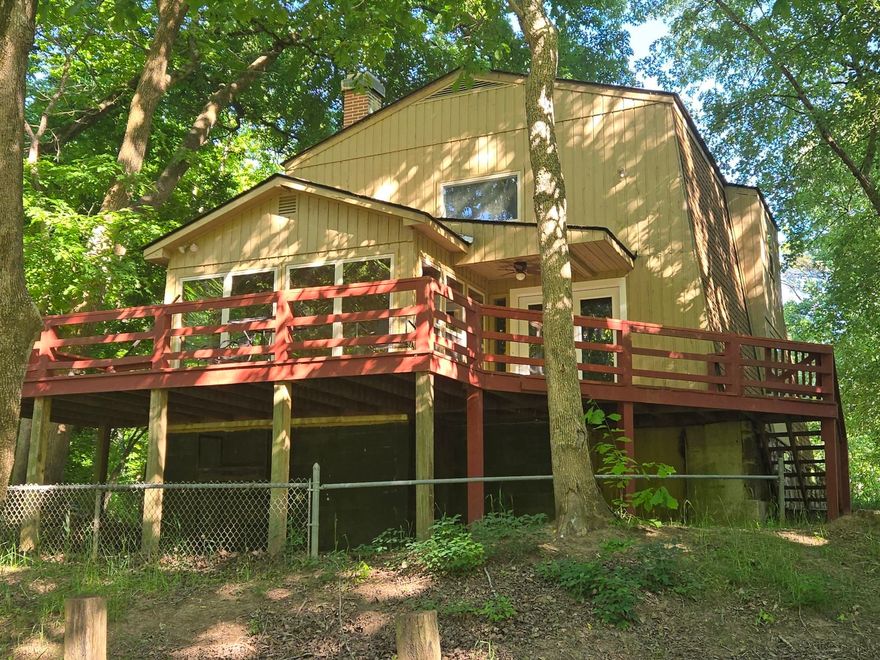 Discover the peaceful charm of riverfront living in this elegant SOUTH FORK RIVER FRONT HOME, offering 60 feet of tranquil water frontage perfect for fishing, swimming, and kayaking. With 1,668 square feet of inviting living space—1,148 on the main level and 520 upstairs—plus a full unfinished basement for generous storage, this home is ideal for comfortable family living or a serene weekend retreat.   Take in sweeping river views from the sunroom’s surrounding windows or through the French doors off the living room. Spacious decks at both the front and back of the home create perfect settings for summer BBQs, morning coffee, or quiet evenings listening to the soothing flow of the South Fork. Inside, the main level features a welcoming 14x22 living room with a natural stone wood-burning fireplace, an open kitchen and dining area, the sunroom, the primary bedroom, and a full bath. The second level offers two additional bedrooms, another full bath, and a loft area—ideal for work, play, or relaxation. Recent updates include new luxury vinyl flooring throughout the main level and a suite of new stainless steel kitchen appliances: stove, microwave, refrigerator and dishwasher.