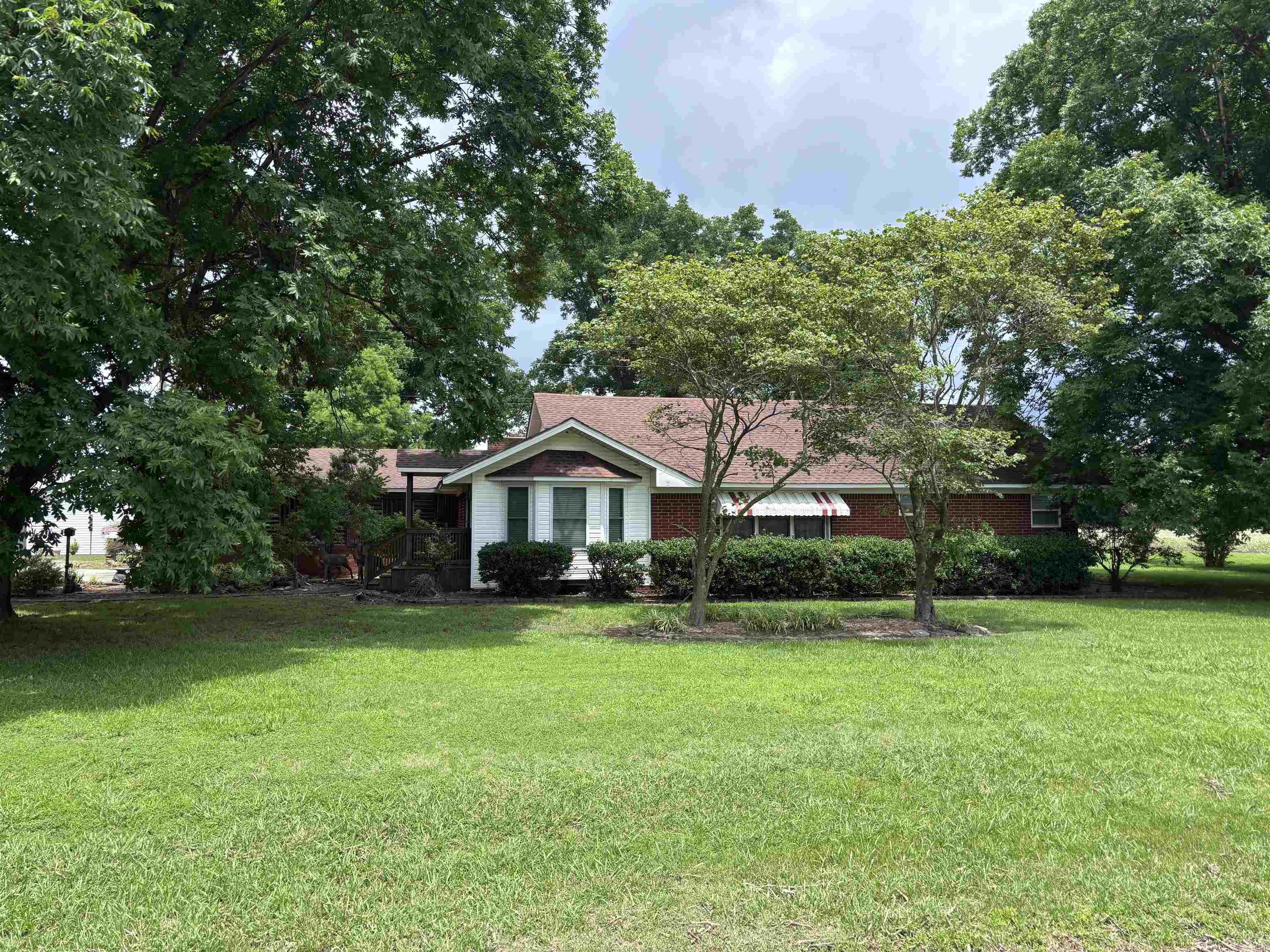 Discover the perfect blend of comfort and convenience with this charming home located just outside the city limits. Featuring 2 spacious bedrooms and 2 full bathrooms, this home also offers a cozy den, ideal for relaxing or working from home. Step outside and enjoy the peacefulness of a full acre of land, providing plenty of space to spread out and enjoy the outdoors. A large shed with its own kitchen offers endless possibilities for entertaining, hobbies, or additional workspace. This property gives you the privacy of country living while still being just minutes from town.