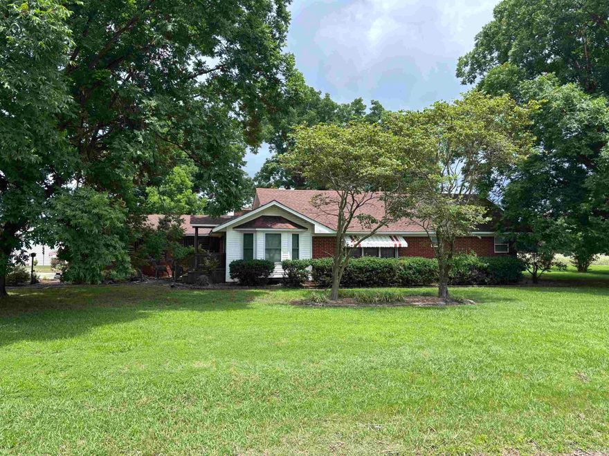 Discover the perfect blend of comfort and convenience with this charming home located just outside the city limits.  Featuring 2 spacious bedrooms and 2 full bathrooms, this home also offers a cozy den, ideal for relaxing or working from home.  Step outside and enjoy the peacefulness of a full acre of land, providing plenty of space to spread out and enjoy the outdoors.  A large shed with its own kitchen offers endless possibilities for entertaining, hobbies, or additional workspace.  This property gives you the privacy of country living while still being just minutes from town.