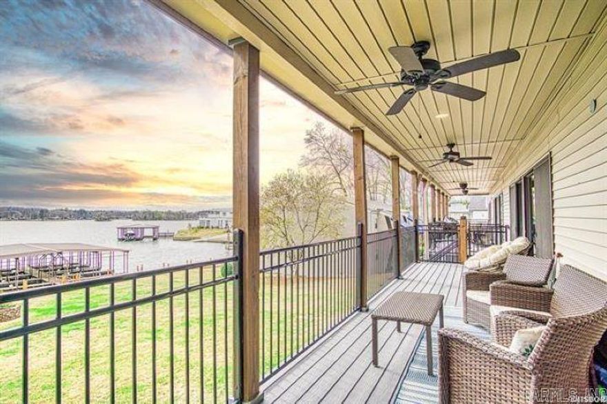 Experience the rare charm of this exquisite 3-bedroom lakefront condo, offering breathtaking views and an unparalleled setting along the serene shores of Lake Hamilton. Just short, scenic 3-mile drive to Oaklawn Racing and Casino, this condo provides sweeping panoramic vistas of the tranquil waters, all set within a picturesque, park-like environment. Inside, you'll be welcomed by rich hardwood floors that exude timeless elegance complimented by a stunning stacked stone fireplace that serves as the heart of the living space. The chef-inspired kitchen boasts granite countertops, elevating every culinary experience. Step outside to the expansive deck, where you can relax while overlooking the sparkling pool nestled in the peaceful surroundings. With just a 100 foot stroll to the lake's edge, your ensuring a serene and exclusive retreat for residents to savor.