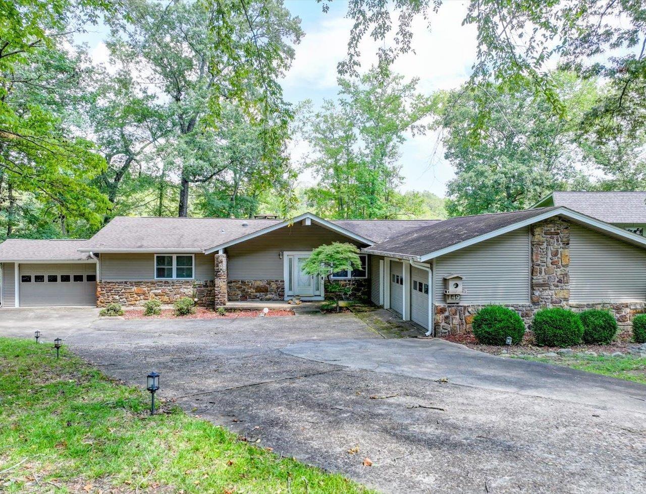 Diamondhead Lakefront home situated on .50 acres with a gentle slope leading to breathtaking views of Lake Catherine. This remarkable contemporary home features an outstanding open floor plan with a sunken great room that showcases a wall of windows overlooking the lake and a stunning rock fireplace. The spacious kitchen and dining area include a deck for outdoor dining. Furnishings are included. The primary bedroom features an en-suite bathroom and a private deck, providing a perfect spot to take in the magnificent views. There are also roomy second and third bedrooms. See Floor Plan in attachments. Additional amenities include three garages and a bonus basement, which is unfinished but has electricity. The large backyard is fenced with chain-link fencing, and there's a lakeside floating boat stall with a dock and ramp. The scenic drive through the area is lined with quality homes, all overlooking Lake Catherine. You will love this home!