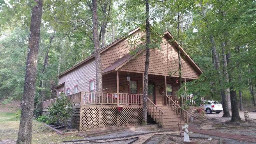THIS HOME OFFERED RENT-TO OWN!  Why just rent? Own your own little piece of Paradise! Beautiful cabin-like home built on a 4.6-acre wooded lot.  This home is great for empty-nesters that need lots of elbow room. This home has a single bedroom (loft), 2 full bathrooms, and plenty of living space.  Upstairs: bedroom, bath with shower, walk-in closet, den/sunroom.  Downstairs: Kitchen, living room, full bath, dining/sunroom, laundry area.