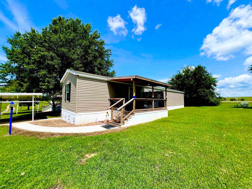 Move-in ready modern living! This stunning 2023 designer mobile home in desirable 55+ River Bend Park boasts an open concept layout, perfect for entertaining. A contemporary kitchen with island overlooks the large great room. Featuring a spacious primary bedroom with walk-in closet and en-suite bathroom. Beautiful laminate plank flooring throughout. The second bedroom is separate from the primary bedroom and next to second full bathroom. Unwind on one of the two new decks and enjoy the tranquility of the country. Paved walkways from decks take you to the 2-car covered carport. Convenient access to amenities in Gassville – groceries, dining, and the city park. Right down the road from the historic town of Cotter and the majestic White River. River Bend Park boasts a community pool, clubhouse and mowing included. BONUS: $500 Credit to Buyer’s closing costs for a closing by August 30th. Don't miss your chance to enjoy this hidden gem!