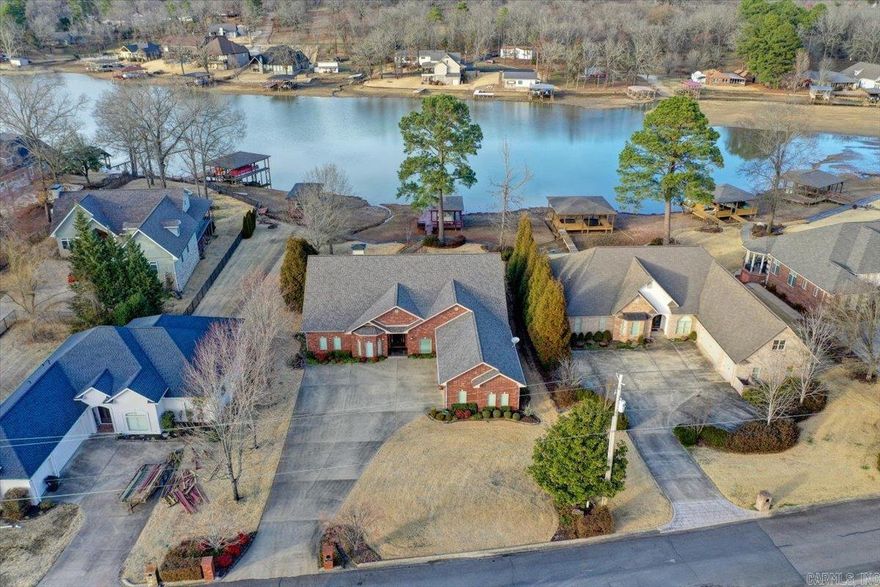 Lake Hamilton Waterfront home with covered boat dock.  Experience the ultimate lakeside luxury in this breathtaking 3500+ square-foot one owner home, nestled on the water's edge. This immaculate property boasts 4 bedrooms and 3.5 bathrooms, creating a serene sanctuary for lakefront living.   The spacious open-concept layout surrounded by expansive windows that offer beautiful views of Lake Hamilton.   Detailed crown molding and high ceilings  The large 3-car garage.  Impressive 100' +/- of Lake Hamilton shoreline, complete with a private boat dock. The large covered patio is an entertainer's dream, offering an outdoor kitchen area that overlooks the stunning lake views – the perfect setting for hosting gatherings or simply enjoying the tranquil ambiance of lakeside living.