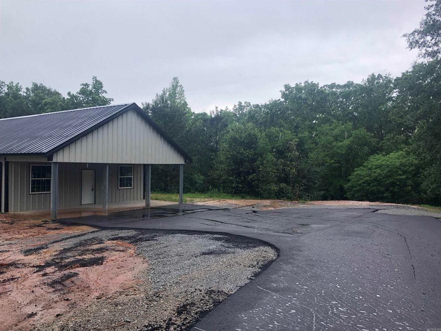 New barndominium shell. 1500 sq ft with 12 ft covered front porch. New asphalt driveway. New slab. 3 bedroom septic permit in hand. Wood terrain community and interior development is ongoing and expected completion is late fall. Power and rural water along the road with Fiber Optic Internet. 16 miles to Little Rock. Approximate frontage 188 sq ft. Make it yours!