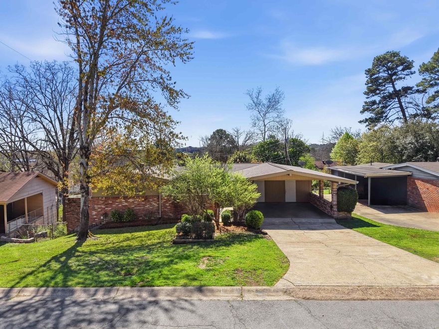 Don’t miss this midcentury modern charmer conventionally located in the Midtown area of Little Rock. The home welcomes you with a large private courtyard, perfect for entertaining or relaxing outdoors. Inside, the spacious sun-filled living room you will love the wall of floor-to-ceiling windows, vaulted ceiling, fireplace and how it flows directly into the bright sunroom. The kitchen offers a breakfast bar and overlooks the main living space, creating an open and functional layout. Just off the kitchen is a flexible bonus room that can serve as an additional living area, office, playroom, or dining space. On the opposite side of the home are two guest bedrooms, a full bath, and the primary suite. The primary suite highlights midcentury design elements with large windows and a vaulted ceiling. A spacious deck off the sunroom overlooks the fully fenced backyard. The lower level includes an additional bonus area that is not currently heated or cooled but could easily finished for a workout room, office, or studio. There is additional area under the home that offers plenty more storage space. Updates -HVAC 6/25, paint & carpet 2026, deck 2025, roof 2019 & more. *Agents see remarks