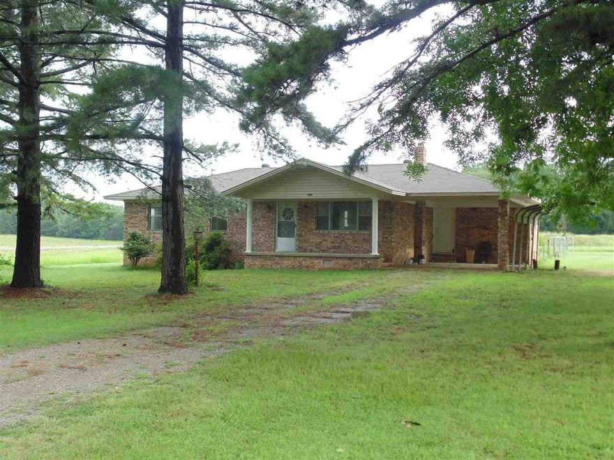 Very well-kept 3BR/1.5BA brick home located on a recently surveyed acre of land with mature trees, city water, central heat/air, new heat pump, propane gas heater for back-up heat in living room, BRAND NEW septic system, newer roof, dishwasher, ceramic tile floors, carpet replaced recently, refrigerator stays, spacious laundry/mud room with cabinets, double vanity in hall bath, deck, big backyard & a great garden spot, & more.  Home is located at the end of dead-end road & private!