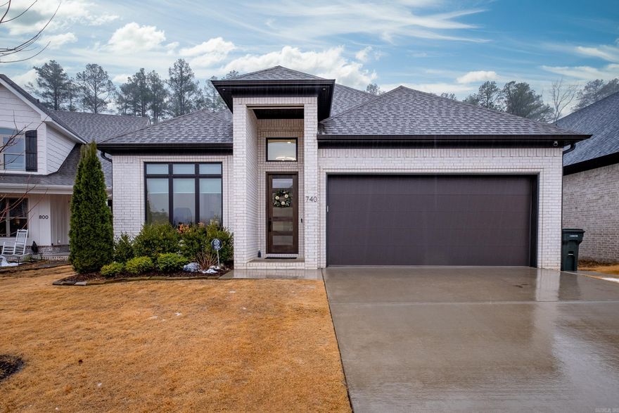 Beautiful modern like-new construction in Wildwood Place! Tall ceilings invite you into the open flow of the formal dining room into the kitchen and living space. Luxurious quartz kitchen counters with stainless appliances, sleek white cabinets, gas range, pantry, and breakfast bar. Great room features gas log fireplace, wood flooring overlooking the outdoor covered veranda. Primary bedroom suite on main level has tiled walk-in shower, double vanities and massive walk-in closet. Also on main level is powder room, laundry room and a guest bedroom suite with a walk-in closet and an en-suite bathroom. Upstairs are two more bedrooms and full bath, plus walk-out floored attic space for easy store. The covered outdoor patio has wood-burning fireplace and looks out onto private, fully fenced level yard with a view of wooded greenspace. Front and back sprinkler systems, tankless water heater and two-car garage. Home is completely wired with Cat5 ethernet, with dedicated ethernet ports in each bedroom, living room, TV surface and outdoor TV space. Refrigerator, Fridge, security cameras (doorbell, indoor/outdoor) all convey. This is a gem!