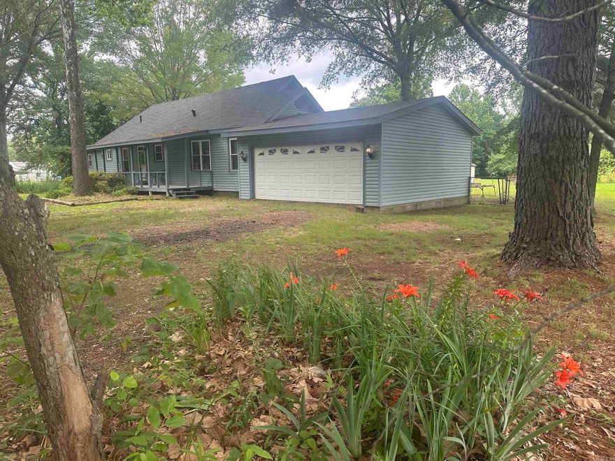 Country home on nice acreage that is cleared, level and surrounded by trees. Back yard acre is fenced and pretty private.  Original home is older-age unknown (guess age at 1950). Master bedroom and bath added around 1995 and carport converted to garage in 1996.  Home has city water plus a well for yard care. OMG-check out the bear clawed bathtub!! Updates: roof 2023, heat pump 2017, well pump 2017,  kitchen/dining remodel 2001, main bathroom remodel 2005, primary bed/bath remodeled 2007, and new vinyl windows and patio door in 2009.  Add your decorating touches and make this your "Home Sweet Home" !!   See agent notes for disclosure and more updates.