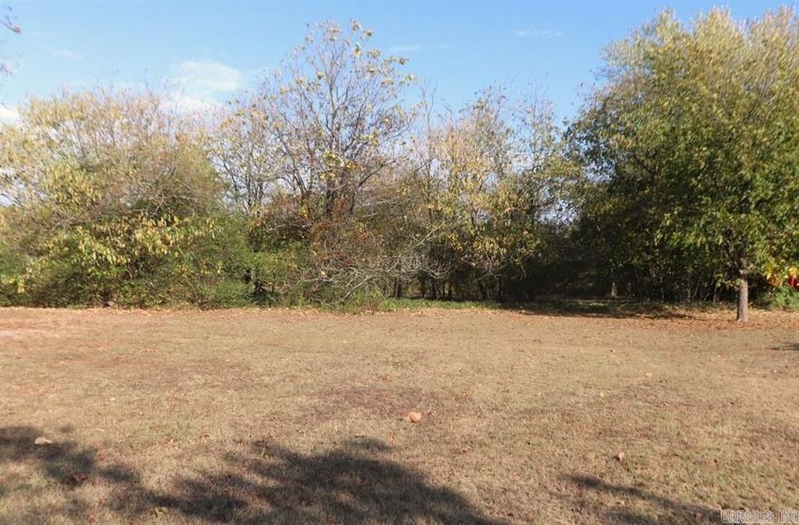 7 acres, over 65 forty year old pecan trees, small pond, spring fed at the back of the property. City water and sewer on the property as well as natural gas and electricity. Building on property is sold AS IS and has no value. Mineral Rights Will NOT Convey. 100% Financing available. Contact Listing Agent. See agent remarks.