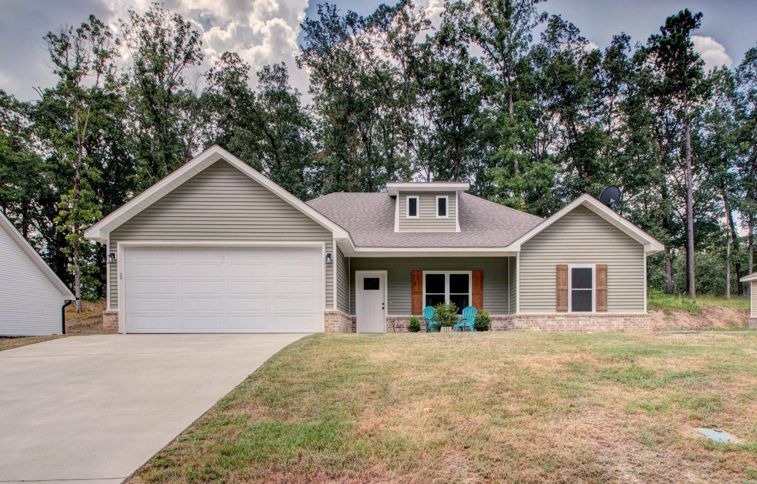 Welcome Home to the Prestigious Gated Diamondhead Golfing Resort Community 18 Hole PGA Par 72 Golf Course. 123 Stonebriar was built in 2022, very well maintained LIKE NEW. Home offers 1535 SQFT of Open Concept Design Living with a 3 Bed /2 Bath Split Floorplan. Exterior is wrapped in Beige Brick base with Sage Green Vinyl Siding, trimmed in Matte Black Lighting and Hardware. Interior offers natural lighting, a Spectacular Spacious Kitchen with Granite Countertops, Custom Cabinetry, Pantry and luxury vinyl flooring throughout. Main Bedroom has a dream en suite with double sink vanity, walk in shower, soaking tub and an impressive walk in closet. Extra bedrooms are generously sized. Laundry Room off Kitchen, 8 FT tall Garage Door with oversized Garage. Property Backs up to woods. Amenities Include Golf Course, Club House, Playground, Swimming Pool, Banquet Room, Boat Ramp, Library, Tennis Courts, Basketball Court, 19th Hole Restaurant, Cafe, Grocery and Beauty Salon.