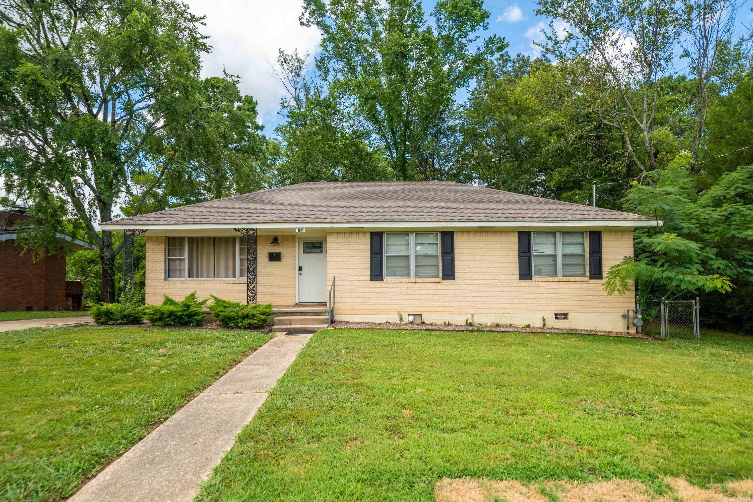 This fully-furnished brick cottage is located in the heart of Hot Springs, just One mile from Oaklawn racing. Currently an income-producing nightly rental, this city home is selling turnkey - with all appliances and furnishings conveying. You'll love the updated and well-kept interior featuring 3 beds and 1.5 baths with original hardwood floors, a covered back deck, brick construction and a recent roof. The fully fenced back yard offers a peaceful and private space for loved ones and pets alike. Completing the package is a detached one-car garage, offering convenience and additional storage options. Situated in a quaint neighborhood, this property offers a unique sense of community and a friendly atmosphere. Let this house be the newest addition to your investment portfolio, or your new place to call "home". See MLS #: 24026133 for the complete investment package which includes 3 short-term-rental properties.