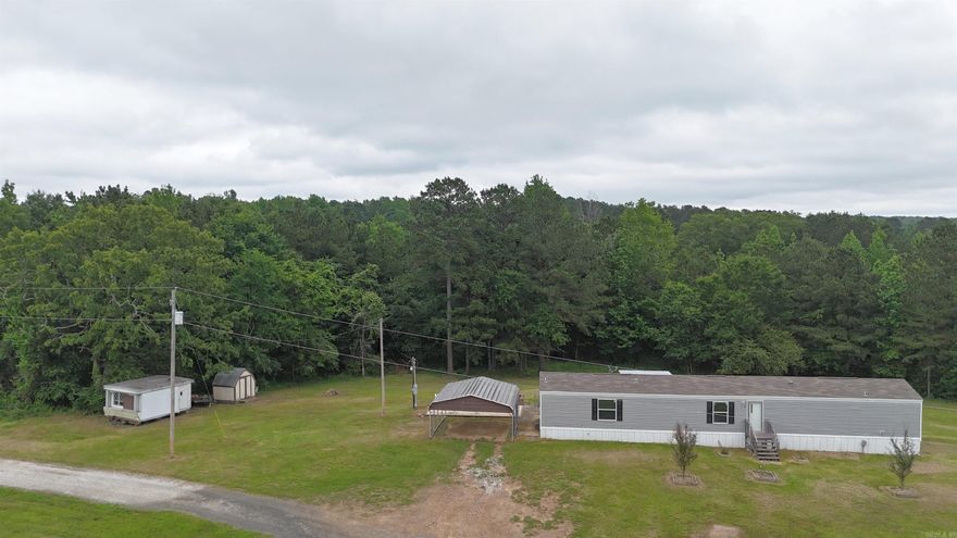 Bismarck Schools - 16 x 76 mobile home on 5.4 acres.  Nice corner lot, only about a mile from school.  Built in 2021.  Includes a metal carport canopy, covered back deck, and chain link fenced back yard.