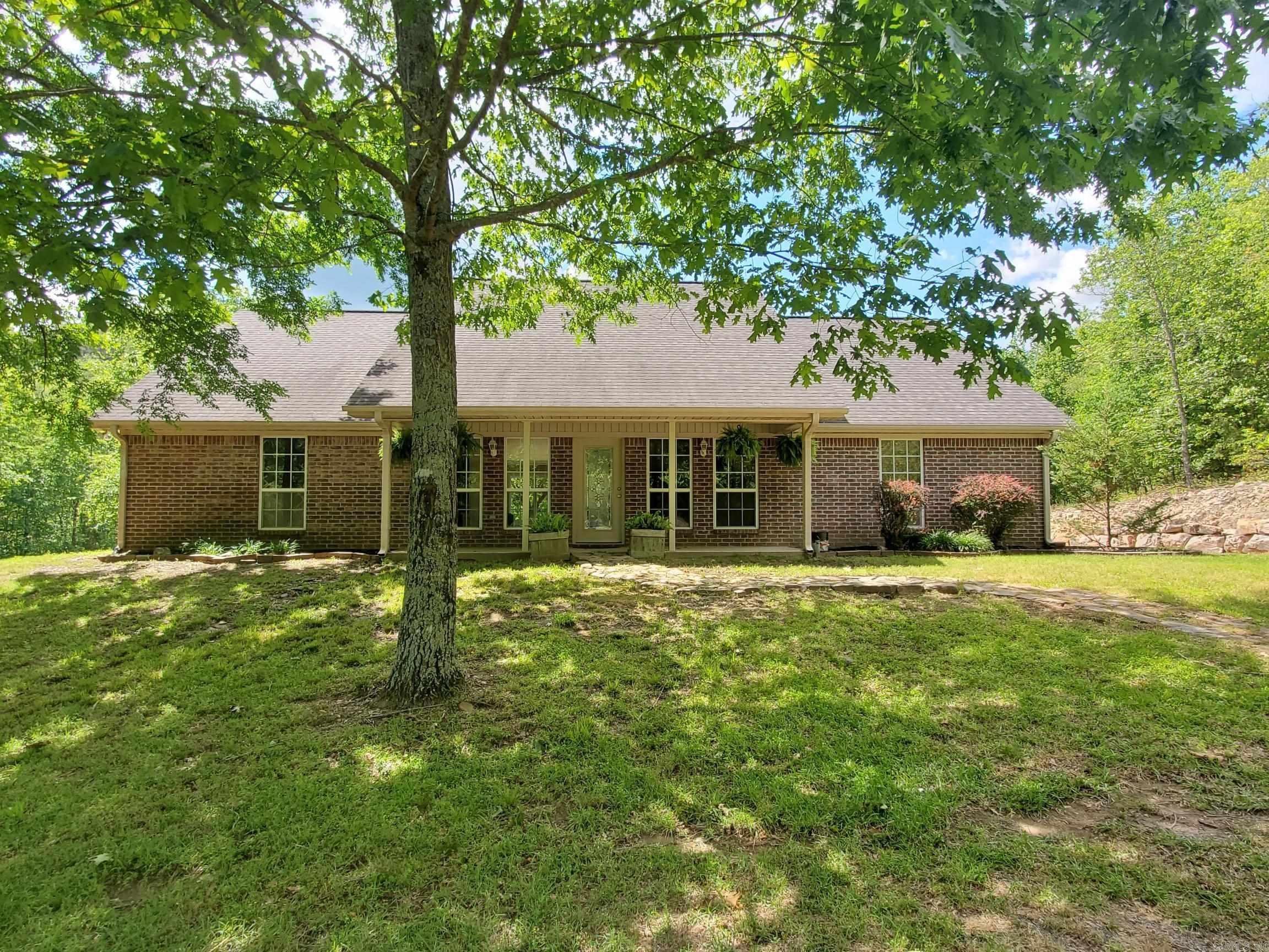 Escape to your own private haven just seconds from Mena! This charming 3-bedroom, 2-bath brick home sits on 10 beautiful wooded acres with creek at the edge of Mena, offering the perfect balance of seclusion and convenience. Inside, you will love the open-concept layout with a split floor plan for added privacy. Stay comfortable year-round with central heat and air, plus a cozy pellet stove for those cooler days. Step outside and enjoy the natural surroundings from your rock patio, perfect for relaxing or entertaining. A double carport provides covered parking, and the storage building offers plenty of space for tools, toys, or projects. Plus, another portable carport. Home wired for a generator. Whether you are looking for a quiet retreat, a place to explore nature, or a family home with room to grow, this property delivers! Do not miss this one-of-a-kind opportunity — schedule your showing today! - 17+ Additional Acres Available