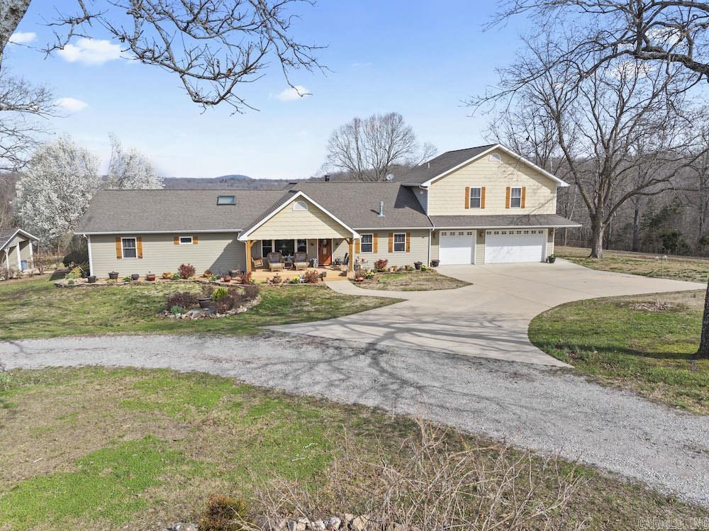 What a stunning home with custom features throughout in an incredible location just minutes to town with the ultimate in privacy and seclusion. Setting tucked back in the hills surrounding the wonderful community of Flippin, AR, is a true gem of a property. This loaded home is at the end of the road and offers the most you ask for in peace and tranquility with the convenience of being 5 minutes from excellent amenities. The stunning setting begins as you drive into the front of the home. You notice the meticulous landscaping and maintenance of the home, along with the custom shutters, large three-car garage, covered front porch, plentiful windows, and warm, inviting colors. Entering the home, you immediately notice the attention to detail and true craftsmanship. The crown molding, ample windows, real hardwood floors, skylights, brick accent wall, and open design all flow together like a symphony to invite you in and speak to your soul. You know instantly that you are home. The large great room serves as the ideal space for hanging out with friends and family. Next to that is the game room, complete with a pool table and a beautiful wood-burning stove for endless fun and comfort.