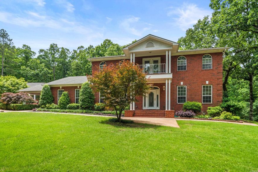 Don't let the Malvern address fool you, this pristine, 6-acre retreat is just MINUTES FROM HOT SPRINGS! Tucked securely behind a private gate, this highly secluded estate offers the ultimate blend of privacy and convenience. A sweeping circular driveway encompasses the home, leading to a covered parking pavilion, two outbuildings, and a barn. The grounds are professionally landscaped, featuring a built-in sprinkler system and leaf guards on the gutters for easy maintenance.  Inside, the spacious floor plan offers 4 bedrooms, including a rare 3 primary suites for unparalleled comfort. An upstairs nook provides the perfect space for a home office. The kitchen boasts new appliances, double ovens, and two pantries. To enjoy the serene surroundings, 4 separate exterior entrances seamlessly connect the indoor living areas to the immaculate outdoor spaces.  This estate offers total peace of mind with a basement tornado shelter and a standby generator. Every detail has been meticulously cared for. Don't let this one get away!