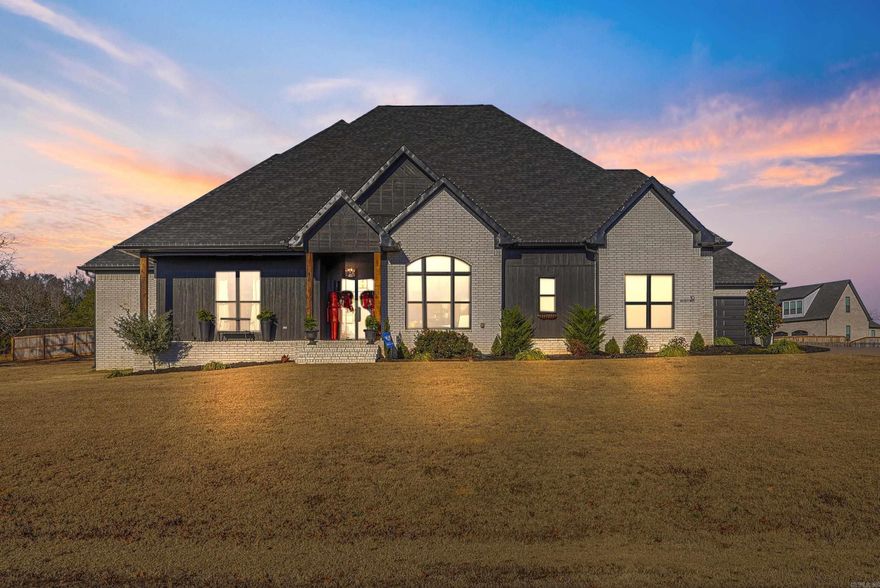 If you’re searching for an exceptional home in the highly desirable Highland Hills subdivision, this one is a must-see. Located at 10 Beckett Drive in Greenbrier, Arkansas, this stunning residence offers 4 bedrooms, 4.5 bathrooms, a bonus room, and a private movie theater, all thoughtfully designed with luxury and functionality in mind. From the moment you step inside, the open floor plan and dramatic glass exterior doors welcome you with an abundance of natural light. Custom floor-to-ceiling cabinetry, striking tile work, and high-end finishes throughout showcase the incredible attention to detail. Storage will never be an issue with a three-car garage, generous closet space, and his-and-hers primary closets. The inviting covered porch is perfect for unwinding, enhanced by hand-selected lighting that creates a warm and welcoming ambiance both inside and out. The kitchen is truly a chef’s dream, featuring an 8-burner gas range, pot filler, walk-in pantry, and stunning leathered granite countertops that are as beautiful as they are functional. From top to bottom, this home is a true masterpiece with no detail overlooked. Luxury, comfort, and style come together seamlessly.