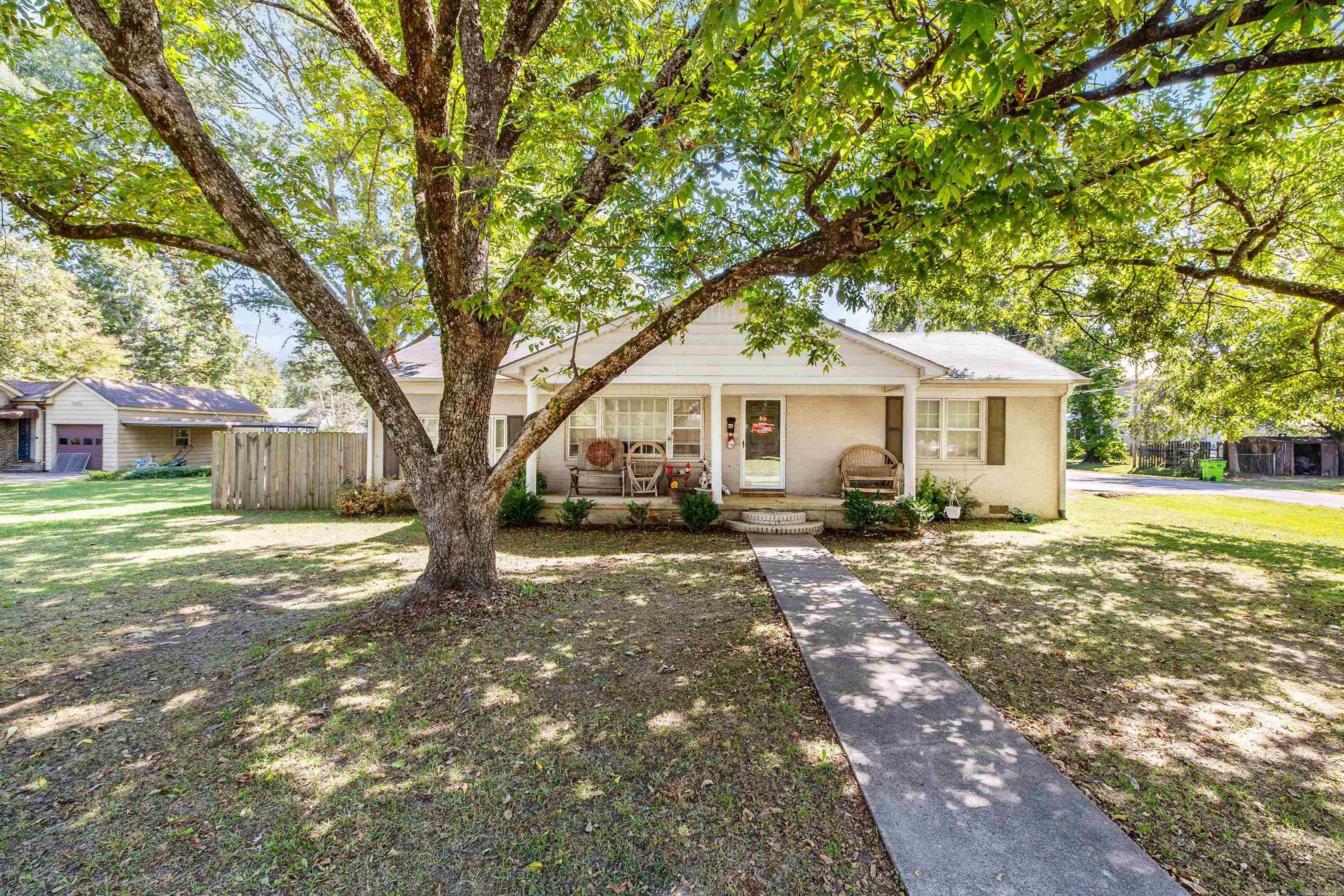 This home in downtown Lonoke is a must-see. The property is approx. 1,809 sq. ft. and sits on a corner lot with well-established shade trees and a fenced-in back yard. Stepping into the home, you're greeted with beautiful vinyl wood floors and a gas log fireplace. In the kitchen, you'll find updated kitchen cabinets, a modern range hood over the island, and stainless steel appliances. The house had a total renovation to the master bedroom, bathroom, closet, and kitchen in 2019. This home has 4 bedrooms and offers great features like a tankless gas water heater, sealed crawl space, high-efficiency HVAC system, and fiber internet access. The seller plans to replace the flooring in the back bedroom, repair some shingles on the roof, and a section of the roof above the carport before closing.