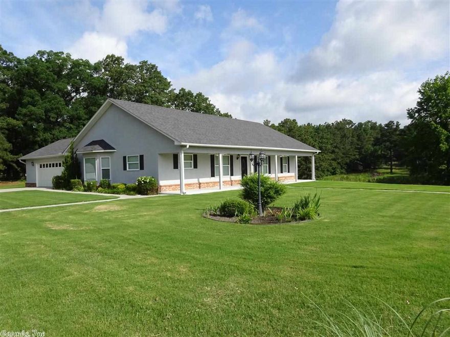 SIMPLE & CHARMING 3 BEDROOM 3 BATH HOME ON 1+ ACRE LOT near Lake Hamilton Schools!  Enjoy front & back covered porches, open living-dining areas, and custom cabinetry!  The kitchen, breakfast & baths have granite, an abundance of windows & custom blinds, and there is a nice master suite with walk-in closets.  Dbl. garage has a separate workshop area and the level sodded yard w/sprinkler system.