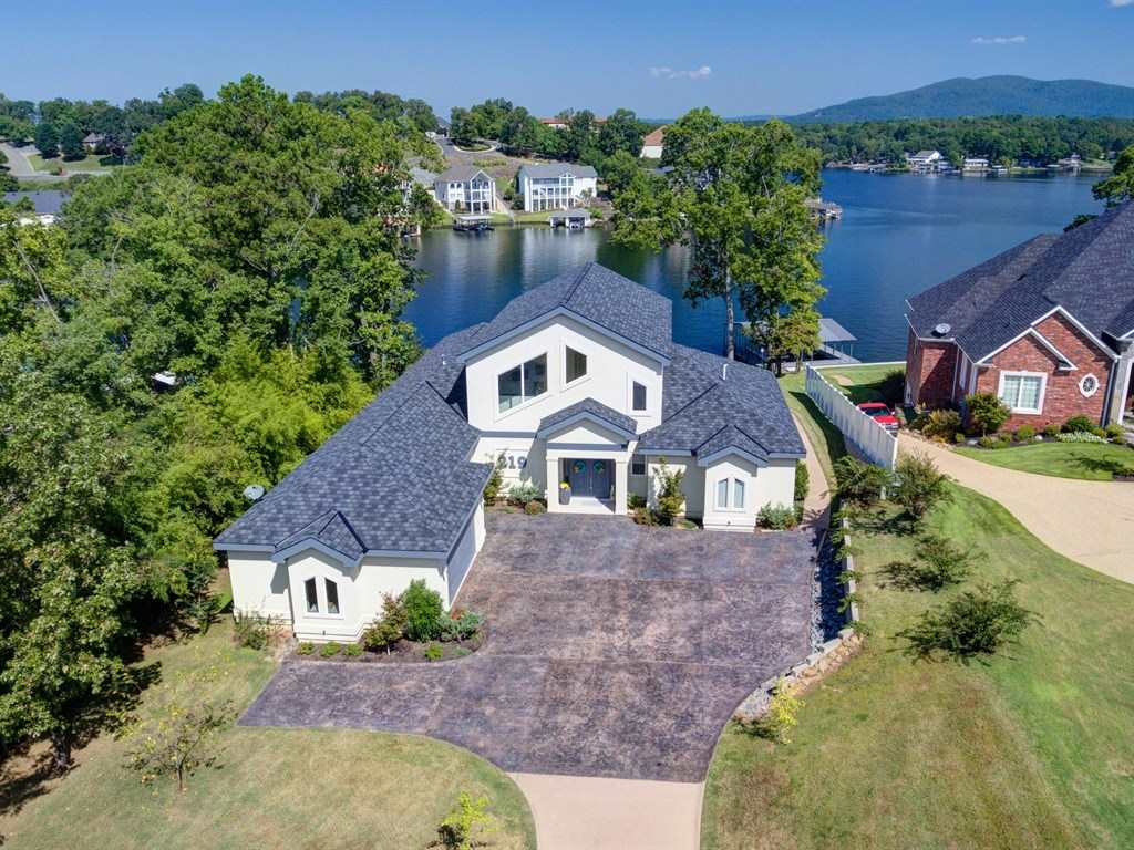 Enjoy year round resort living at your private home! This two-year-old custom home is one of a kind for the entertainer at heart. Heated and cooled pool-side cabana with roll-up glass door. Stationary double boat dock with swim platform. Awesome views of main channel. Salt water pool. Beautiful contemporary home inside and out. Seller is a licensed agent.