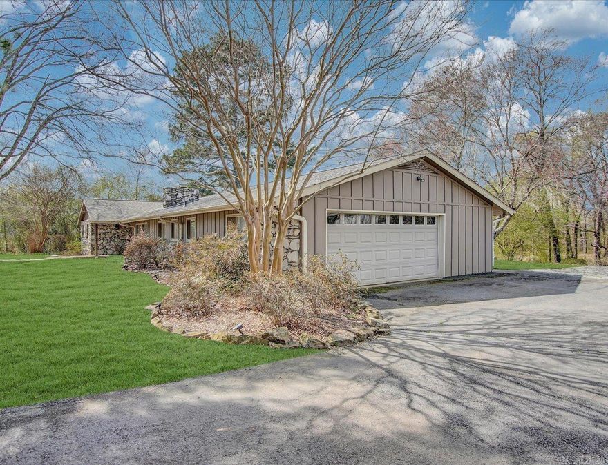 Located in a peaceful neighborhood with a water view from the front of the road and a park-like setting at the back of the home.  This spacious home offers comfort, functionality, and beautiful surroundings. The property features both an attached oversized two-car garage and a large detached two-car garage/shop with a half bath and potential for a guest house / man cave of 490 sq feet.  A circular driveway provides plenty of additional parking and easy access. Inside, the home offers multiple living spaces, including a living room, family room, sunroom, dining area, and laundry room. Additional highlights include four bedrooms, two full baths, crown molding, and a large wood-burning fireplace. The kitchen is equipped with an electric double oven, microwave, and dishwasher. The roof was replaced just one year ago, adding peace of mind for the next owner.